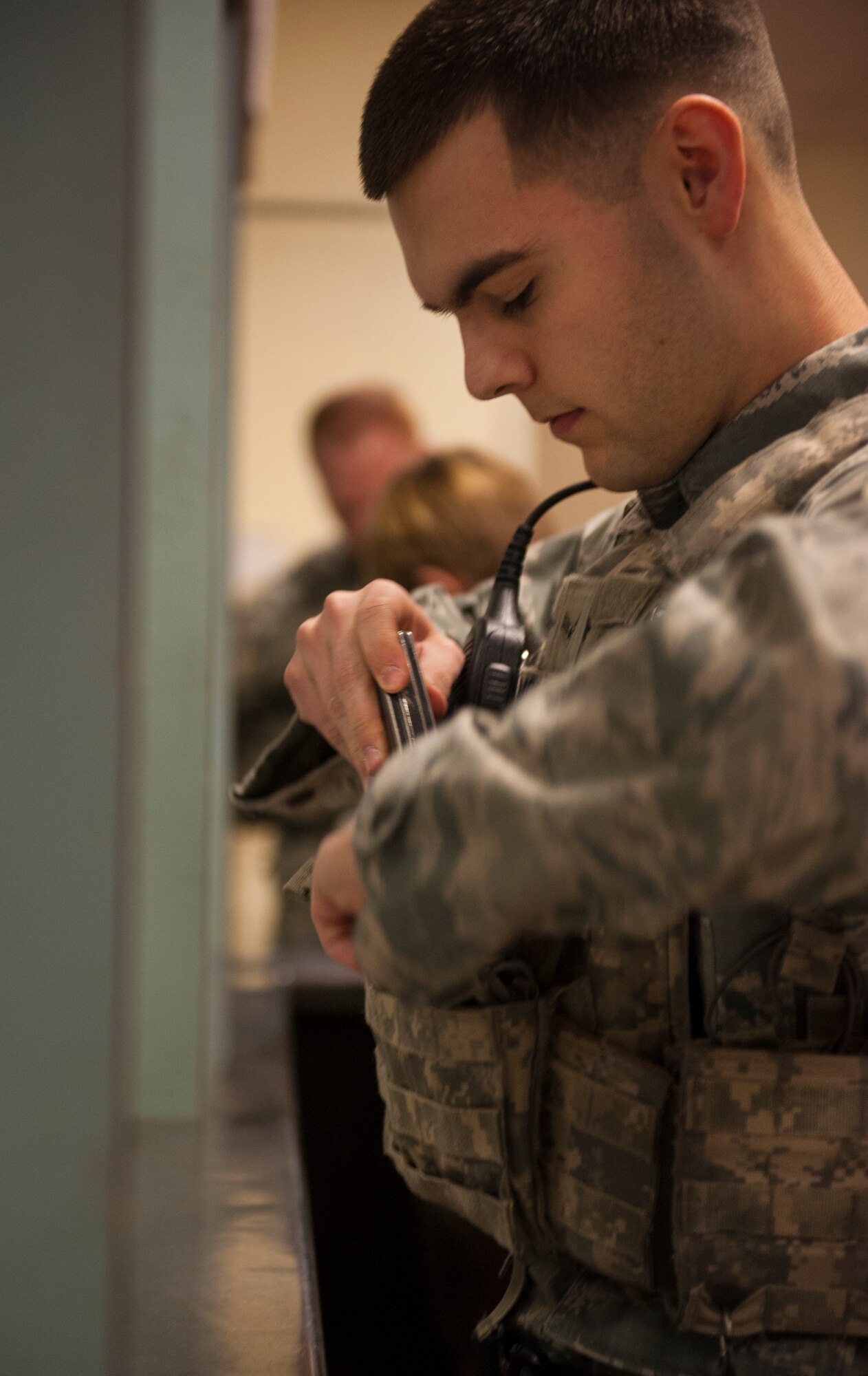 Airman 1st Class Joseph Morrissette, 5th Security Forces Squadron defender, gears up at the Minot Air Force Base armory, Jan. 13, 2014. Security forces members report to the armory before each shift to acquire the proper equipment and weapons. (U.S. Air Force photo/Airman 1st Class Apryl Hall)