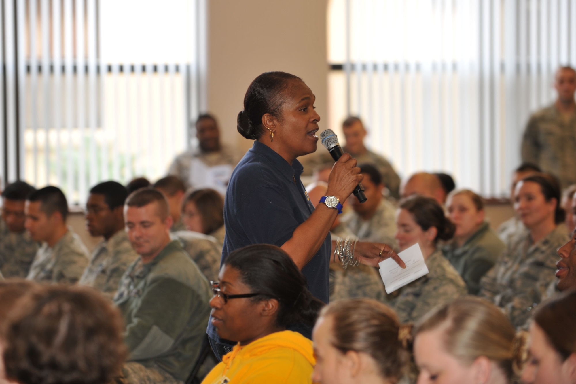 Yvette McKenzie, Department of Defense Dependents School teacher and niece of Dr. Martin Luther King, Jr., leads members of the 65th Air Base Wing in celebration of the life and achievements of Dr. King Jan.17, 2014. The Unity Service featured service members of various backgrounds discussing how Martin Luther King's civil rights efforts affected their cultures. Martin Luther King Day is observed the third Monday in January of each year. The annual theme is "A Day On, Not a Day Off." (U.S. Air Force photo by Staff Sgt. Angelique N. Smythe)