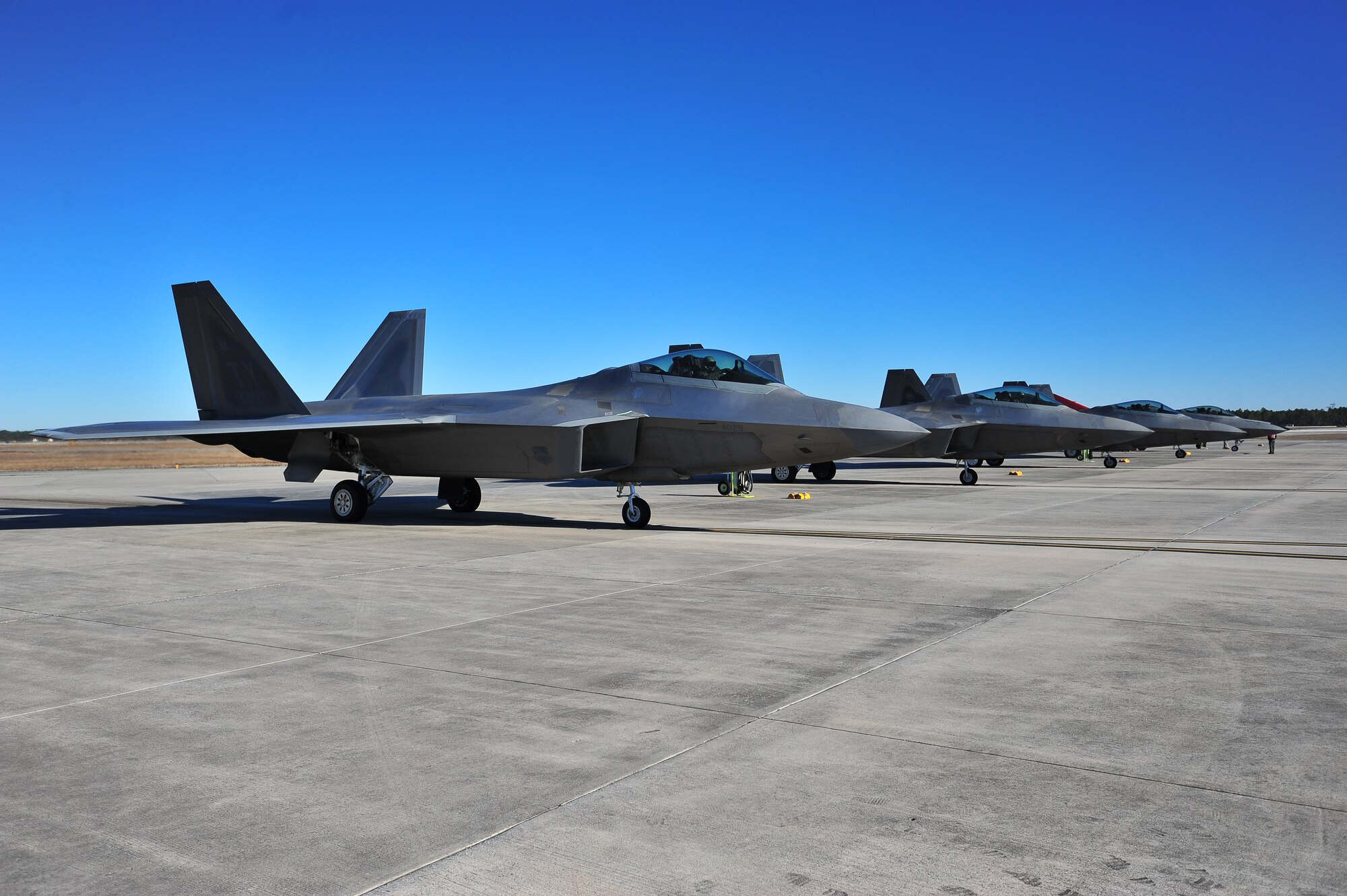F-22 Raptors await the final inspection before flying Jan. 16, at the flight line end of runway. Team Tyndall recently came together for a ‘war day’ to increase the lethality of the 43rd Fighter Squadron and 95th Fighter Squadron’s F-22 Raptor pilots in a simulated air combat mission. (U.S. Air Force photo by Airman 1st Class Sergio A. Gamboa)