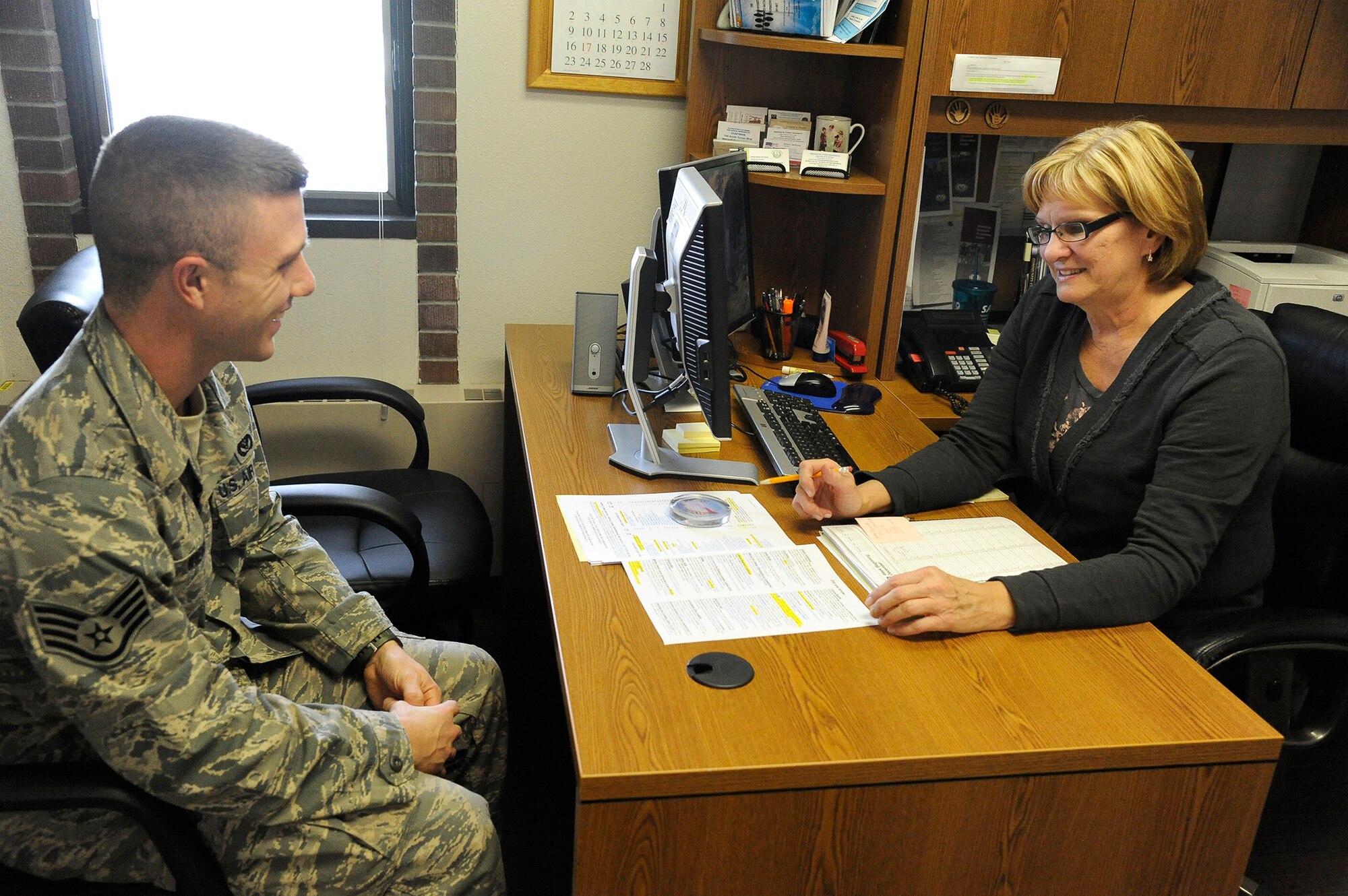 Staff Sgt. Francis Wiener, 819th RED HORSE Squadron First Term Airman Center NCO in charge (left), speaks with Susan Patrick, 341st Force Support Squadron education advisor, about how to apply military educational benefits to his degree Dec. 20. Team Malmstrom members have the option of meeting with a guidance counselor to help develop a plan to achieve their educational goals while still serving on active duty. (U.S. Air Force photo/Airman 1st Class Collin Schmidt)