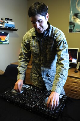 Airman 1st Class Zackery Wade, 341st Comptroller Squadron financial technician, practices live production on a mixing system Jan. 14. Wade produces original electronic dance music and provides entertainment as a disc jockey. His next performance is at Machinery Row in Great Falls, Mont., on Jan. 25. (U.S. Air Force photo/Senior Airman Katrina Heikkinen)