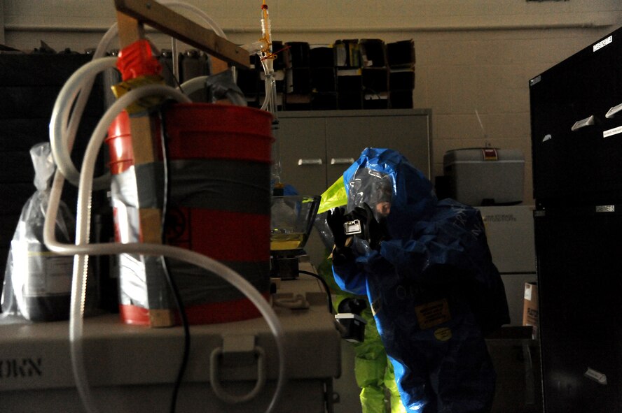 Airman 1st Class Brittany Barat, 341st Civil engineer Squadron emergency management member, documents a simulated clandestine chemical lab with a camera during a joint training exercise at the Montana Air National Guard in Great Falls, Mont., on Jan. 13.  Conditions in the hot-zone were dark and cluttered to add realism and adversity to the training event.  In addition to the challenging scenario, the team battled winds gusting up to 64 mph during the training.  (U.S. Air Force photo/Senior Airman Cortney Paxton)