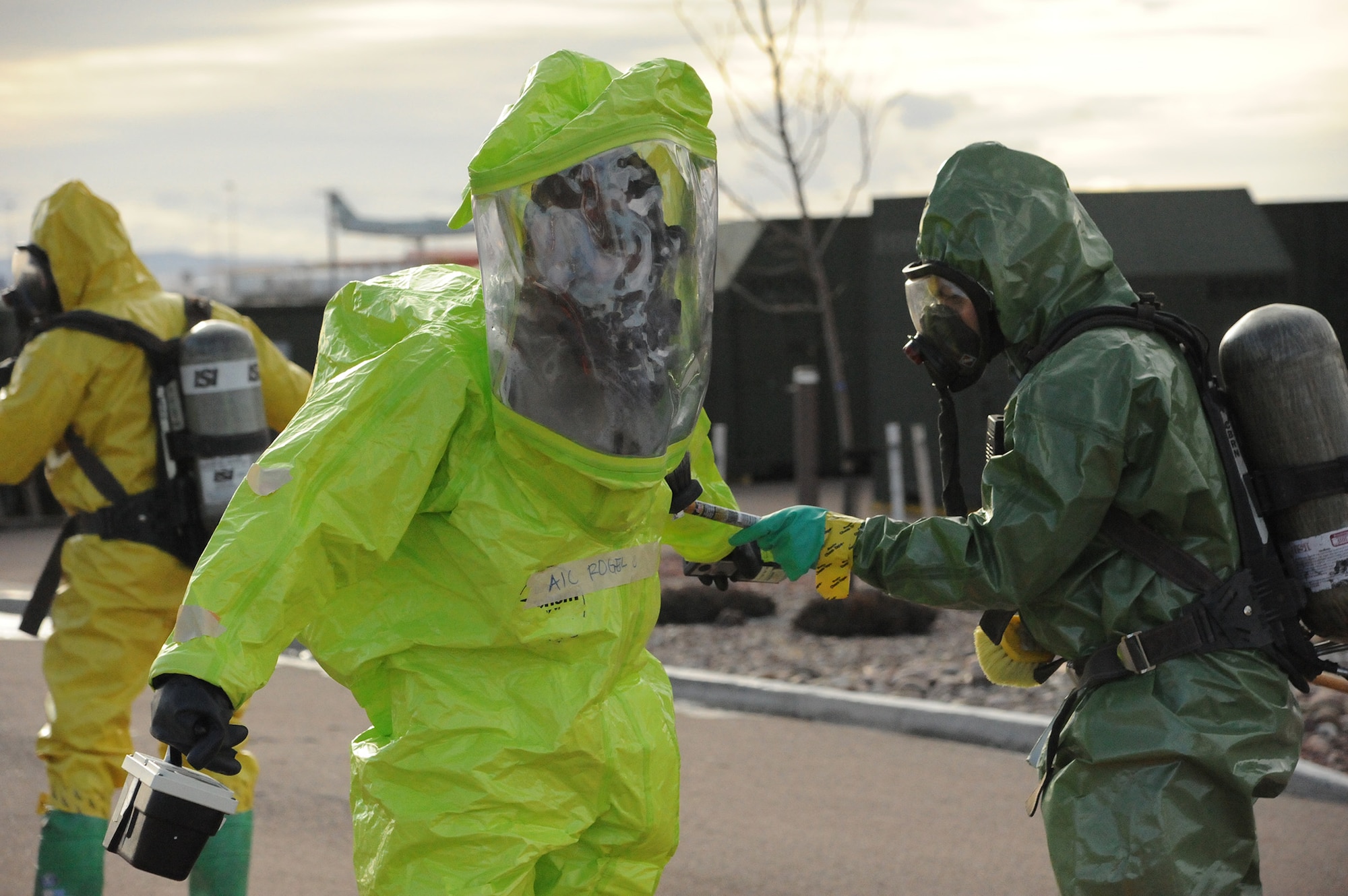 Firefighter 1st Class Chris Newman, Great Falls Fire Rescue and Regional Hazardous Materials Team member (right), simulates the decontamination process with Airman 1st Class Joel Rogel, 341st Medical Operations Squadron bioenvironmental engineer technician.  Rogel along with Airman 1st Class Brittany Barat and Senior Airman Der Her, 341st MDOS bioenvironmental engineers, practiced Chemical, Biological, Radiological and Nuclear Emergency Response Force procedures in the exercise hot-zone Jan. 13. (U.S. Air Force photo/Senior Airman Cortney Paxton)