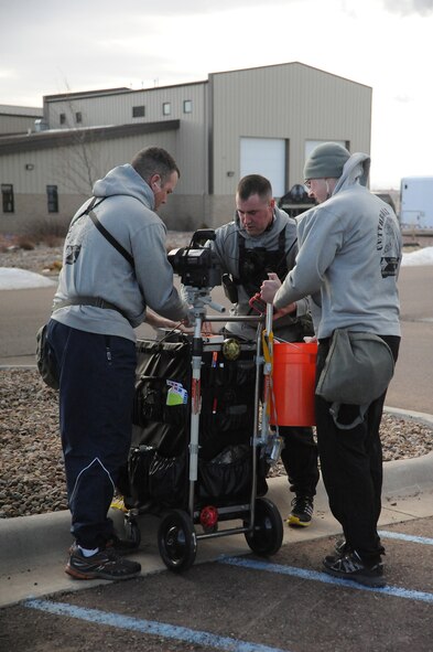 Three members of the Montana Army National Guard’s 83rd Civil Support Team prepare equipment before suiting up to enter the hot-zone of a joint exercise at the Montana Air National Guard on Jan. 13. The 83rd CST members traveled from Fort Harrison near Helena, Mont., to participate in the exercise. (U.S. Air Force photo/Senior Airman Cortney Paxton)