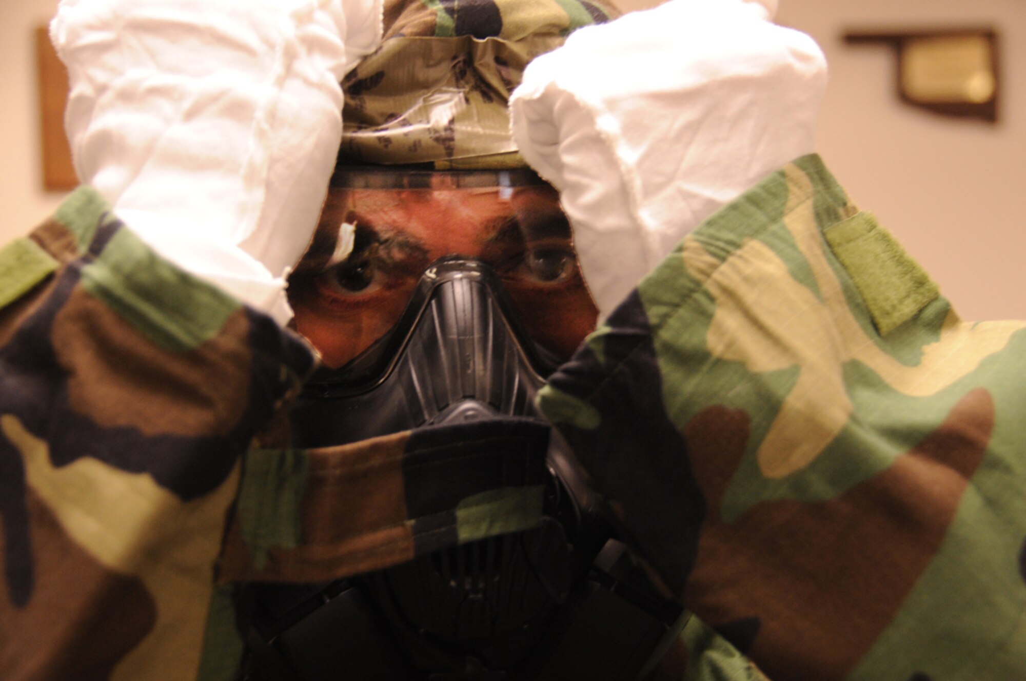 Airman 1st Class Tommy Kirtley, 673d Security Forces Squadron, puts on Mission Oriented Protective Posture gear, during chemical, biological, radiological, nuclear and explosive weapons defense survival skills training – on JBER – Jan. 7. The CBRNE training plays helps ensure Airmen are able to operate and accomplish mission essential tasks in a contaminated environment. (U.S. Air Force photo/Staff Sgt. William Banton)
