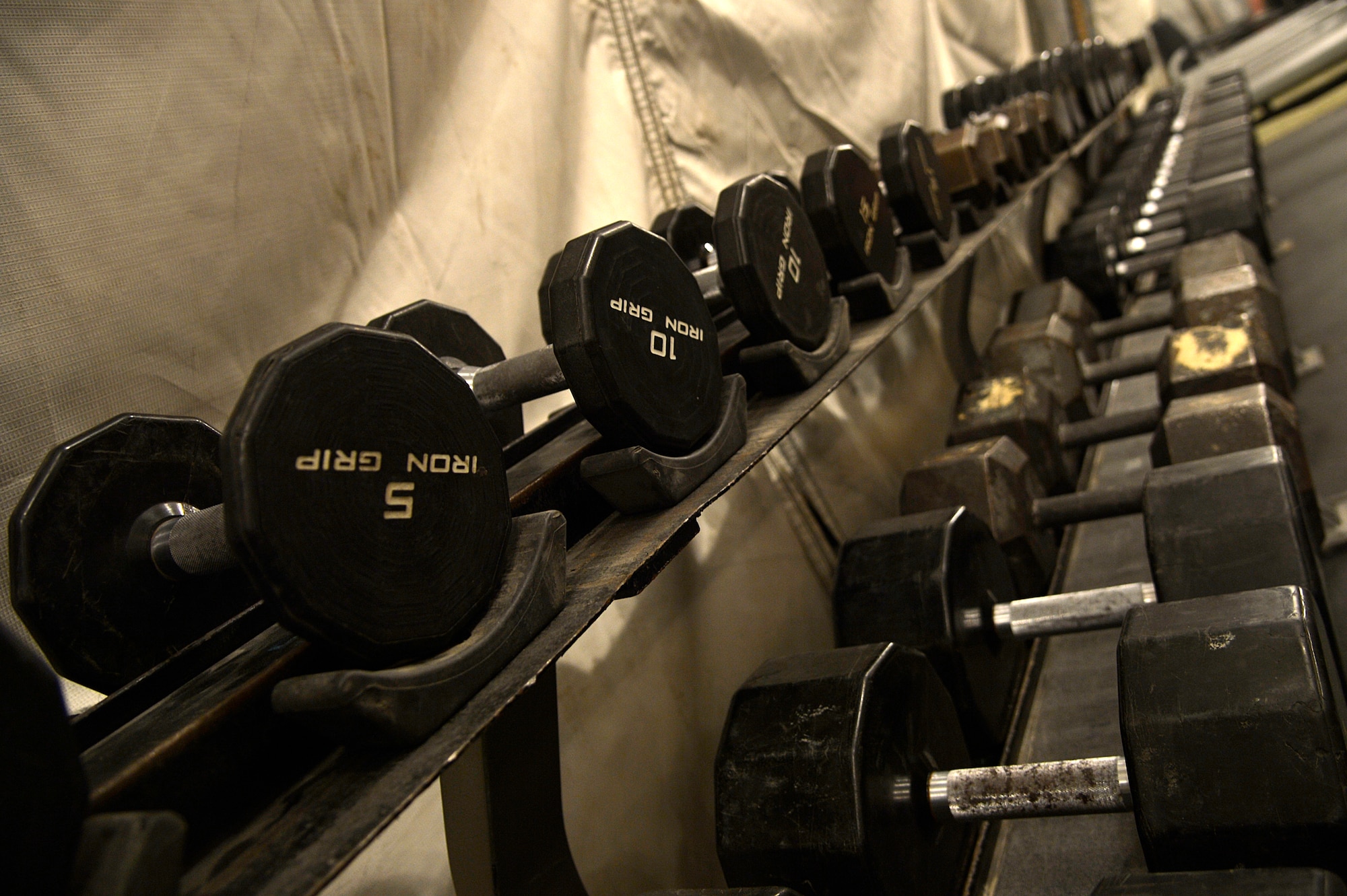 U.S. Service members use a newly opened fitness facility at Bagram Airfield, Jan. 17, 2014. The 455th Expeditionary Civil Engineer Squadron and 455th Expeditionary Communications Squadron built the base and established the shelter with a generator and the required communication equipment.  (U.S. Air Force photo by Senior Airman Kayla Newman/Released)