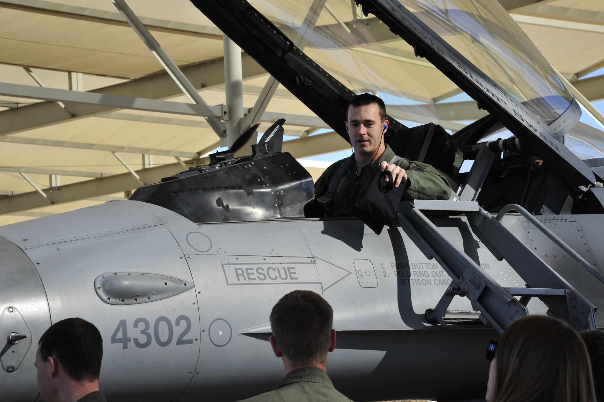 Capt. Joshua Arki, 61st Fighter Squadron instructor pilot and chief of weapons and tactics, is welcomed back Dec. 31, 2013, after his final flight in an F-16 Fighting Falcon on the Luke Air Force Base flightline. Arki was selected as the first Luke F-16 pilot to transition to the F-35 Lightning II joint strike fighter and is currently attending training on the new airframe at Eglin Air Force Base, Fla. He is expected to return to his Luke squadron in March. (U.S. Air Force photo/Senior Airman Grace Lee)