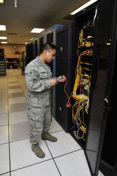 Airman 1st Class Anthony Navarra, 56th Communications Squadron network infrastructure technician, connects an optic light to an optical fiber cable Jan. 8 at the Network Operations Center on Luke Air Force Base. The infrastructure section maintains and manages the various lines of communication for Luke, making it possible to correspond via phone, e-mail, and internet and ensures users have access to the base’s shared drives, servers and more. (U.S. Air Force photo/Senior Airman Grace Lee)