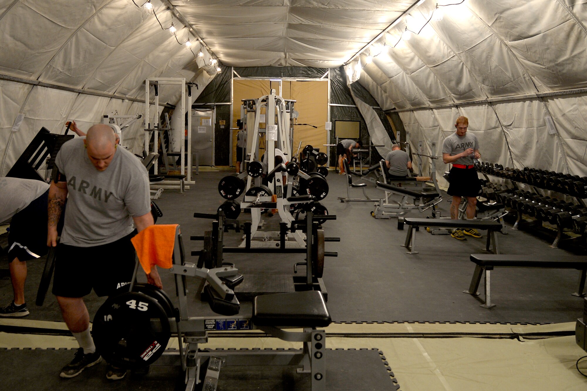 U.S. Service members use a newly opened fitness facility at Bagram Airfield, Jan. 17, 2014. The 455th Expeditionary Force Support Squadron opened the new facility Jan. 8, 2014, after moving the equipment from the Smack Town compound. (U.S. Air Force photo by Senior Airman Kayla Newman/Released)
