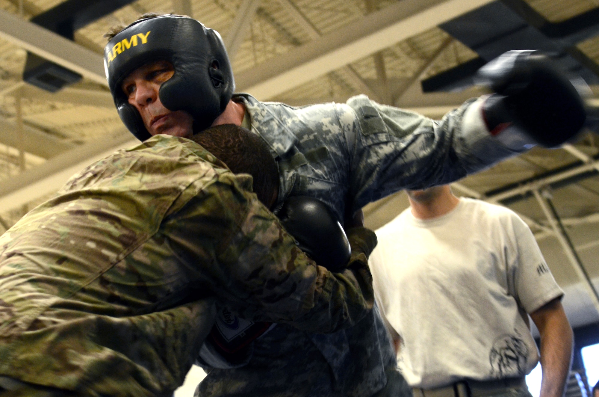 Maj. Daniel Lloyd, a Modern Army Combatives Program (MACP) Basic Combatives Course Level 1 Instructor assigned to the 1st Battlefield Coordination Detachment, hits a student during the Modern Army Combatives Program (MACP) Basic Combatives Course Level 1 at the Benko Fitness Center on Davis-Monthan AFB, Ariz., Jan. 13, 2014. MACP is a 40-hour course that focuses on three phases of basic fight strategy; close the distance, gain the dominate position, and how to finish the fight. (U.S. Air Force photo by Staff Sgt. Heather R. Redman/Released) 
