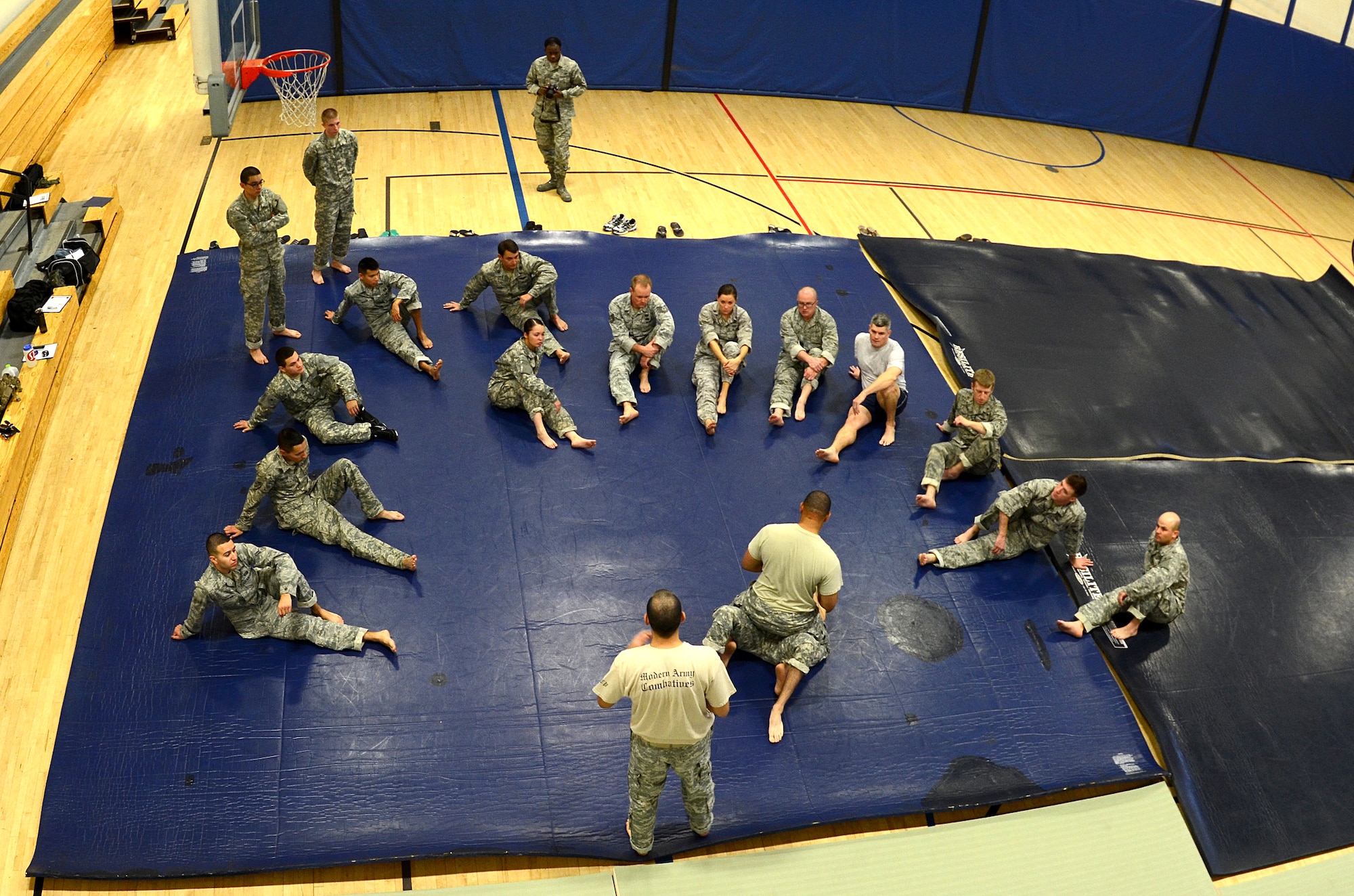 Airmen from 12th Air Force (Air Forces Southern) and Soldiers from the 1st Battlefield Coordination Detachment attend the Modern Army Combatives Program (MACP) Basic Combatives Course Level 1 at the Benko Fitness Center on Davis-Monthan AFB, Ariz., Jan. 13, 2014. MACP is a 40-hour course that focuses on three phases of basic fight strategy; close the distance, gain the dominate position, and how to finish the fight.  (U.S. Air Force photo by Staff Sgt. Heather R. Redman/Released) 
