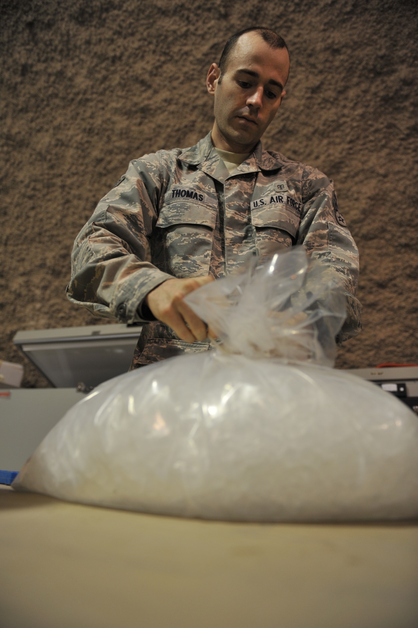 Senior Airman Charles Thomas bags ice for a blood product shipment at the 379th Expeditionary Medical Group Blood Transshipment Center, Al Udeid Air Base, Qatar, Jan. 17, 2014. The BTC serves as the central point for storage and inventory assessment of all blood products in Central Command’s area of responsibility. The BTC ships an average of 600 blood products weekly supporting 43 medical treatment facilities throughout the AOR. Thomas is a medical laboratory technician deployed from Joint Base Langley-Eustis, Va., and a Birmingham, Ala., native. (U.S. Air Force photo by Master Sgt. David Miller)