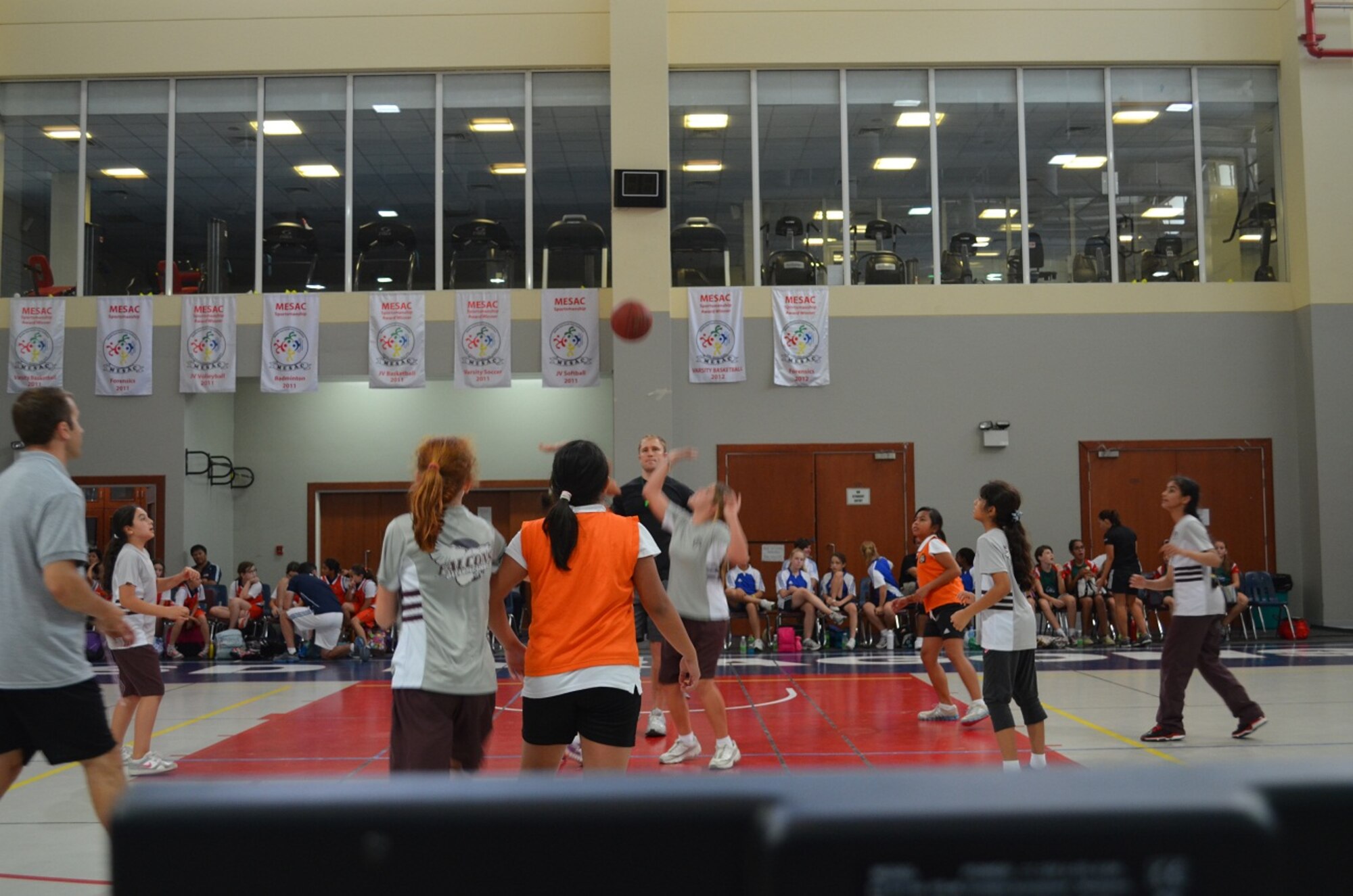 Capt. Karl Bolt, a native of Stockton, Calif. and stationed at Al Udeid Air Base, tosses the opening jump ball at an elementary girls’ basketball game at the American School of Doha.  Bolt is currently serving as the president of Jar Saleh, which is Arabic for “Good Neighbor.”  Jar Saleh is a private volunteer organization at AUAB since 2012, focused on relationship-building engagements in the local community to develop long lasting partnerships and cultivate a sense of community.  Jar Saleh continues to provide the largest number of volunteer hours of all the private organizations on base, averaging nearly 3,000 volunteer hours quarterly.  Bolt is stationed here as a logistics readiness officer for the Air Force Central Command’s War Reserve Materiels. (Courtesy photo)