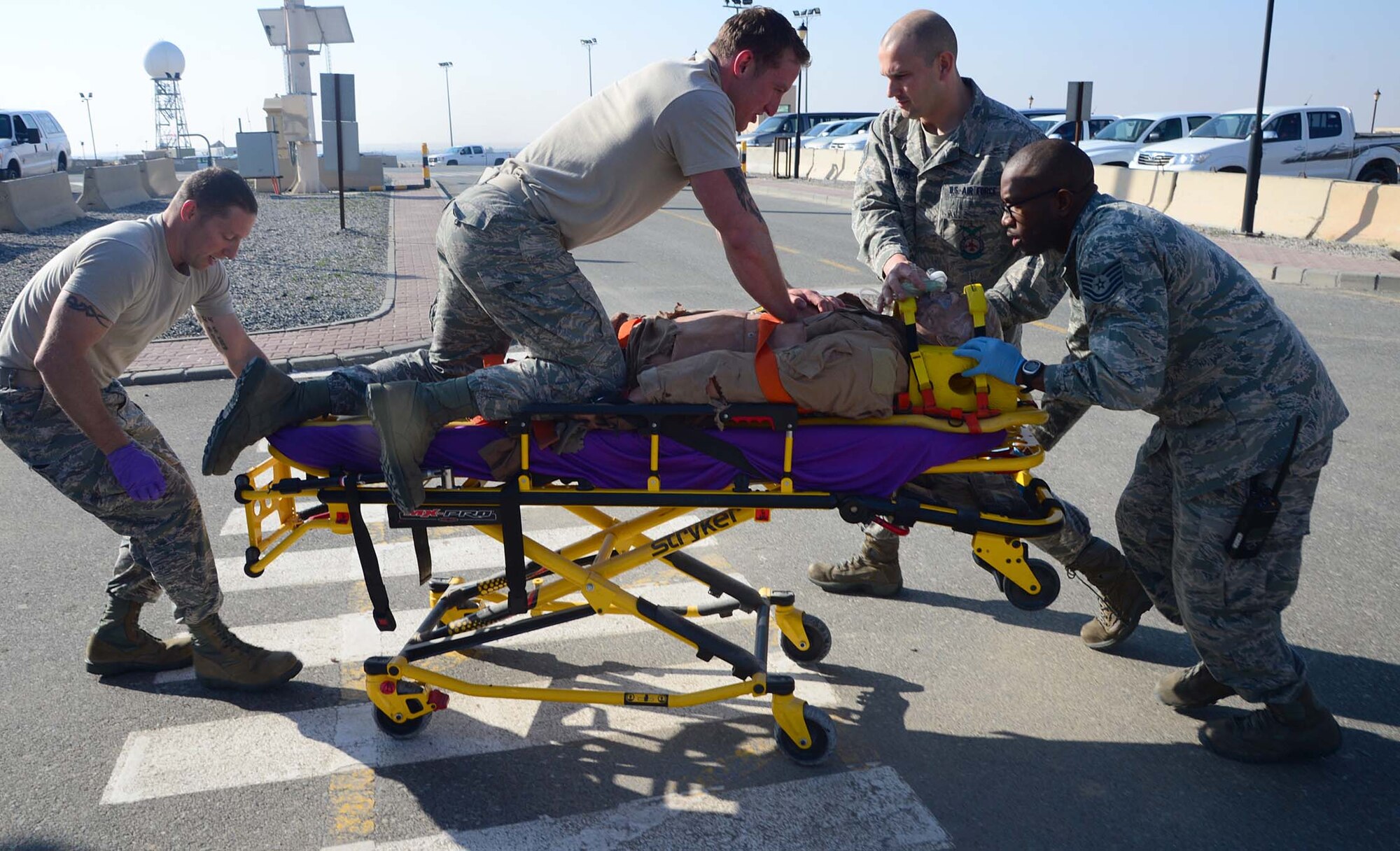 Firefighters from the 386th Expeditionary Civil Engineer Squadron and medical technicians with the 386th Expeditionary Medical Group treat a simulated casualty during an active shooter scenario at an undisclosed location in Southwest Asia. The exercise evaluated emergency responder and personnel aptitude for procedure execution in an accurate and timely manner. (U.S. Air Force photo by Senior Airman Desiree W. Moye)