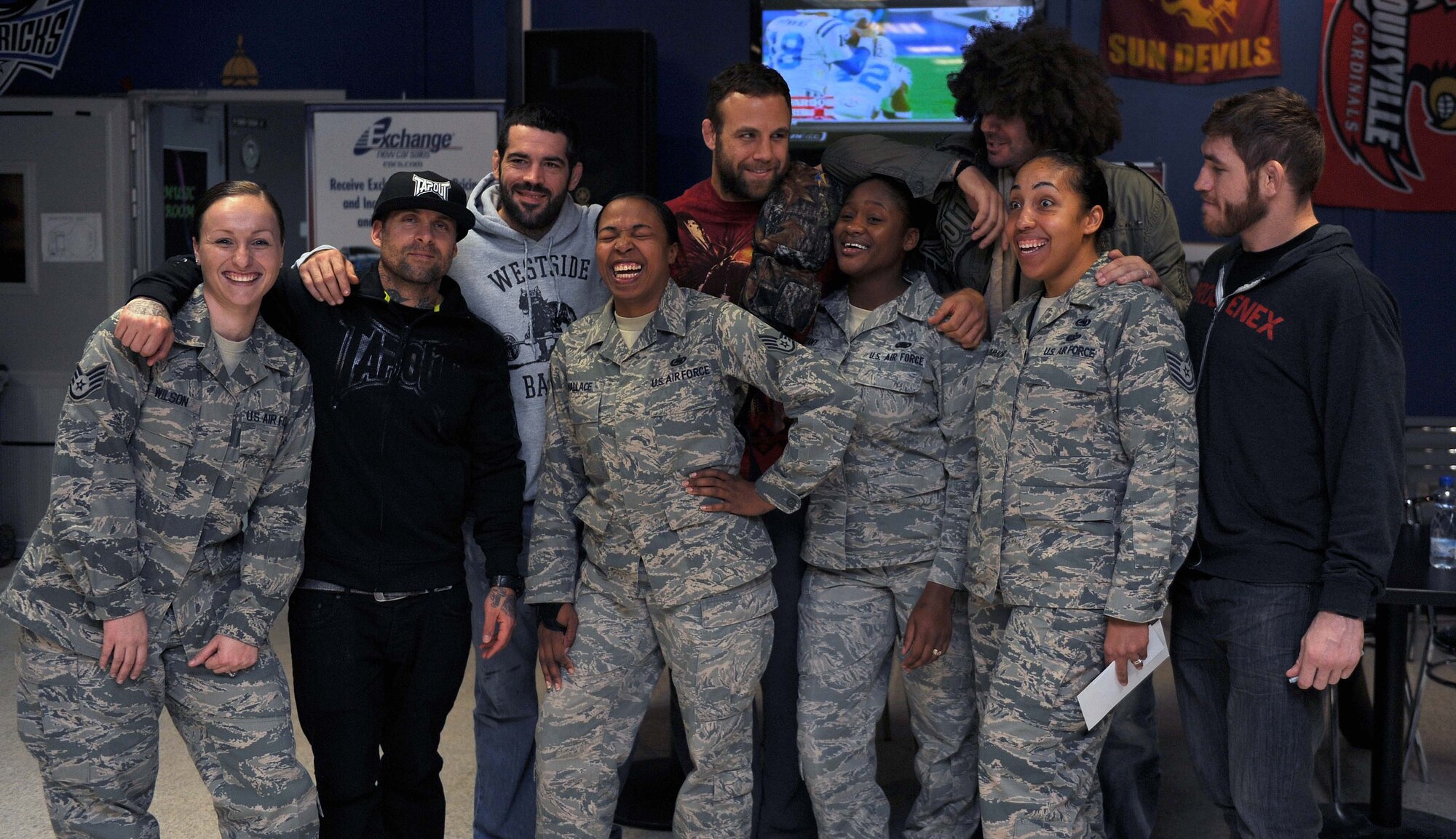 Members from the 386th Expeditionary Force Support Squadron meet and greet mixed martial arts fighters at the Drop Zone recreational facility during their Department of Defense Armed Force Entertainment Southwest Asia tour on The Rock. (U.S. Air Force photo by Senior Airman Desiree W. Moye)