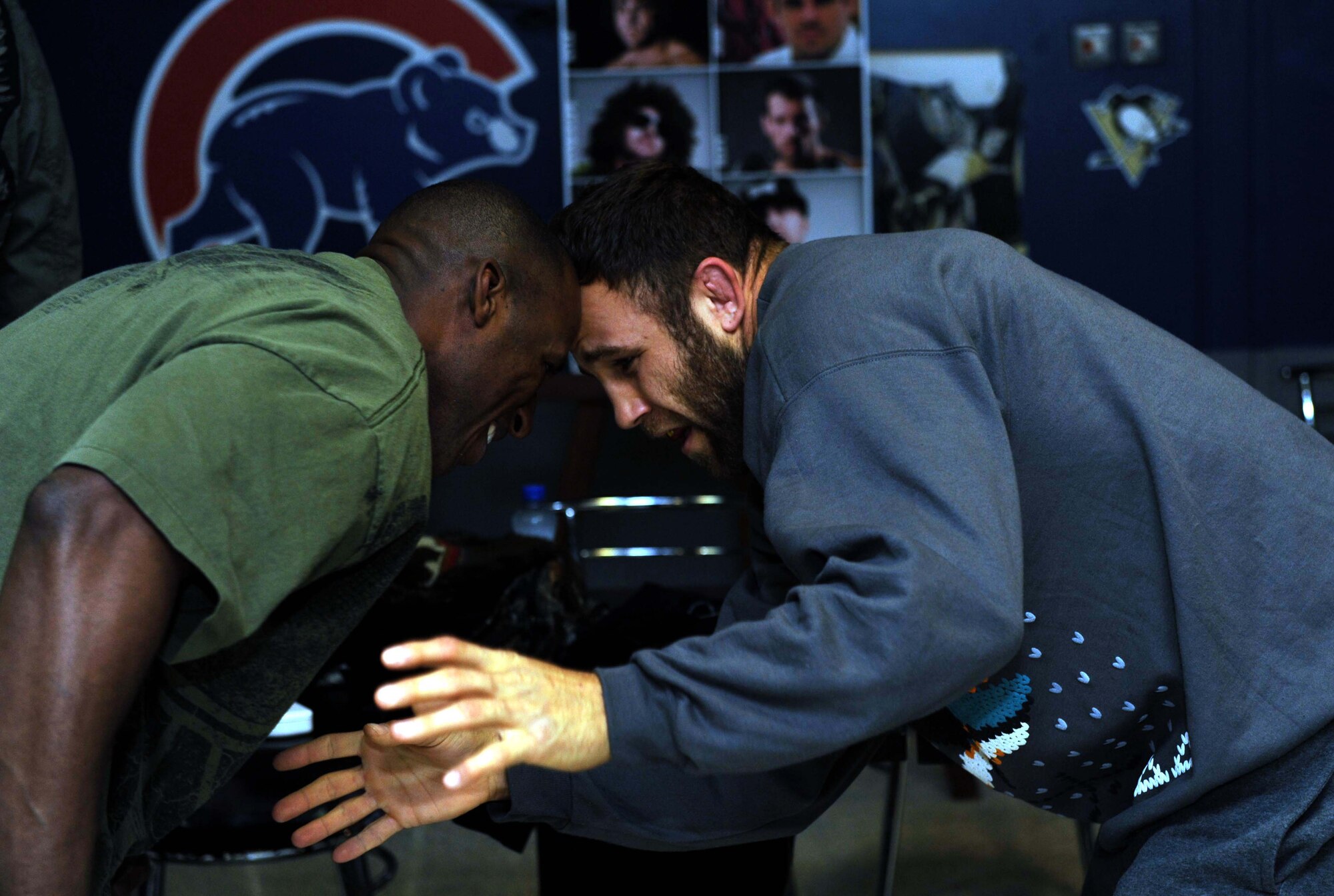 Tech Sgt. Wilsondo Alteus, 386th Expeditionary Force Support Squadron deployment control center liaison officer, takes on his favorite mixed martial arts fighter, Tom Lawlor, during Lawlor’s visit at the Drop Zone recreational facility.  Lawlor met with deployed Airmen while on a Department of Defense Armed Force Entertainment Southwest Asia tour of The Rock. Alteus is deployed from McGuire Air Force Base, N.J., and a native of Royal Palm Beach, Fla. (U.S. Air Force photo by Senior Airman Desiree W. Moye)