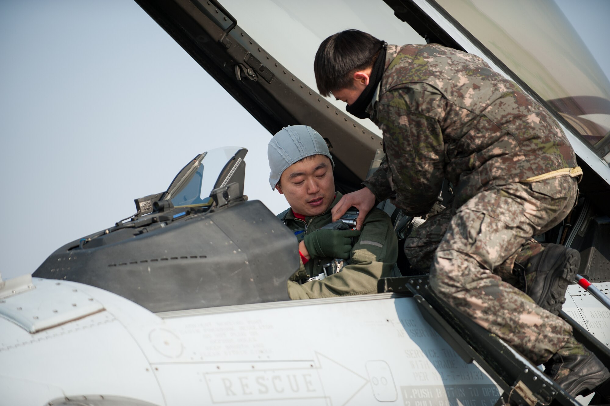 A Republic of Korea air force pilot buckles up before a flight during the exercise Buddy Wing 14-1 at Kunsan Air Base, Republic of Korea, Jan 15, 2014. Buddy Wing is a combined training exercise between U. S. Air Force and Republic of Korea air force pilots to improve communication and combat capabilities to strengthen the peninsula’s combined air power team. (U.S. Air Force photo by Senior Airman Clayton Lenhardt/Released)