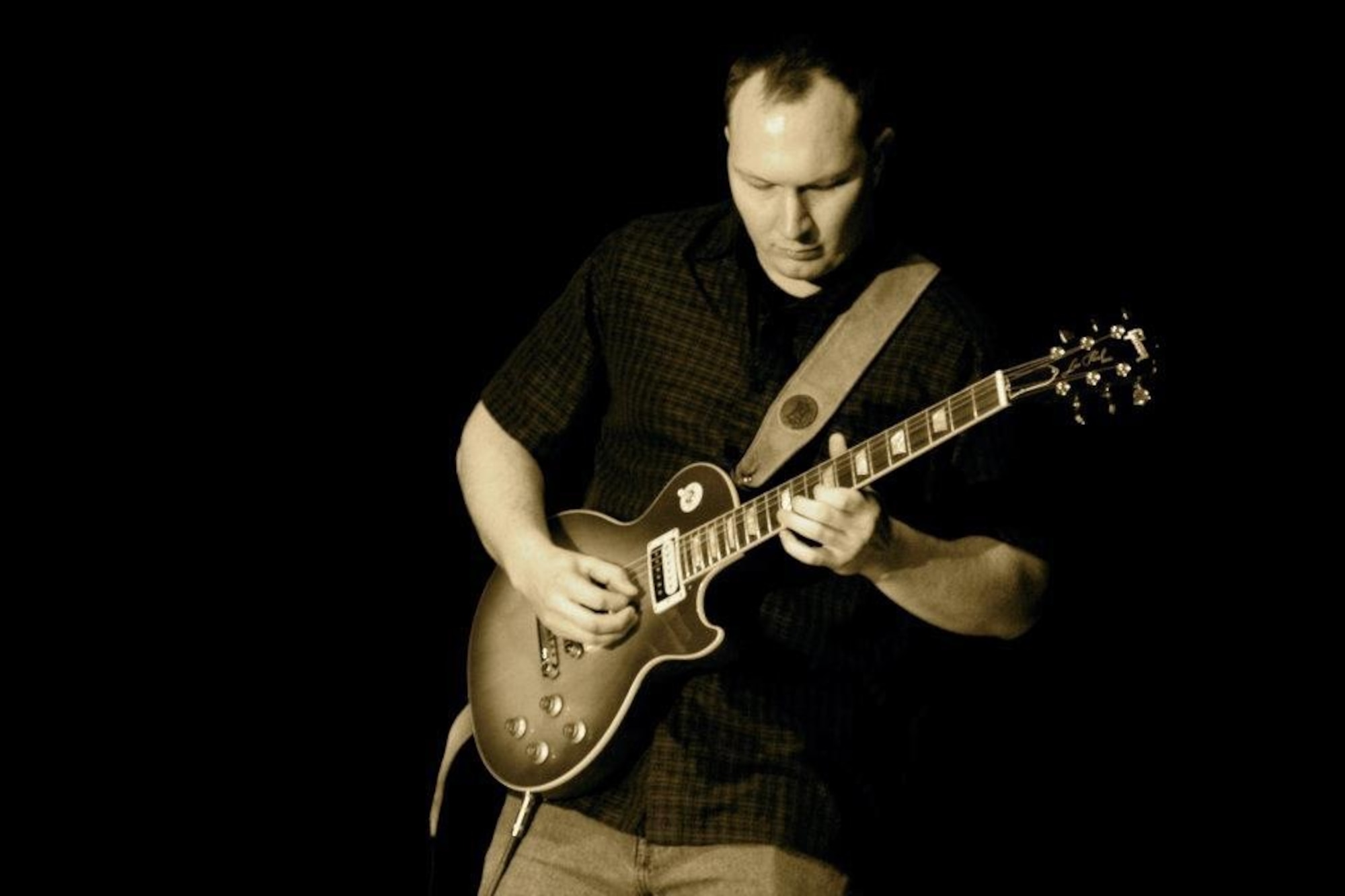 Staff Sgt. Charles Johnson, 374 Civil Engineering Squadron water and fuels system maintenance, plays the guitar during a show.  “I wanted to play music that people could enjoy and dance to,” Johnson said.  (Courtesy photo)