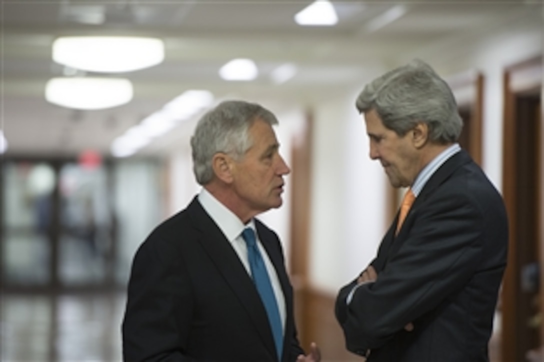Defense Secretary Chuck Hagel speaks with Secretary of State John F. Kerry before hosting the Secretary's Leadership Council at the Pentagon, Jan. 16, 2014. The council includes the commanders of the nine combatant commands and senior civilian leaders.