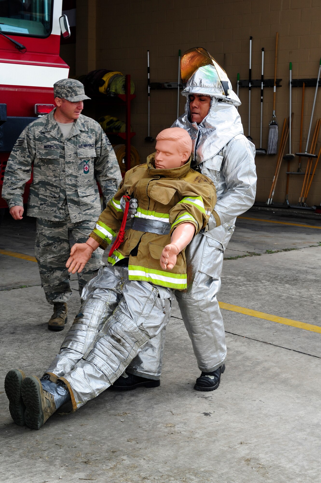 Kerin Barrera, a member of a Honduran fire brigade, drags a 175-pound dummey 100 feet during a fire muster hosted by the firefighters of Joint Task Force-Bravo's 612th Air Base Squadron, Jan. 16, 2014.  Thirty members of local Honduran fire brigades and volunteer fire departments participated in the fire muster, which served to bring U.S. and Honduran firefighters together to build camaraderie, engage in training, and take part in friendly competition.  (Photo by Martin Chahin)