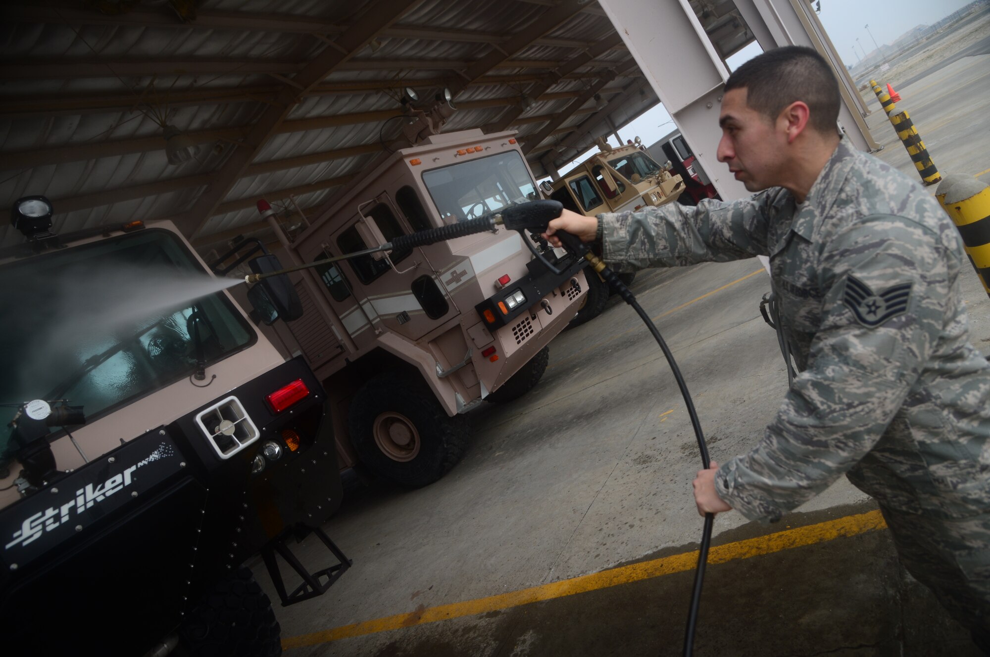 Staff Sgt. Joshua Gonzalez, 386th Expeditionary Civil Engineer Squadron, removes dirt from his fire truck after a long day of training drills at an undisclosed location in Southwest Asia. Gonzalez is a firefighter deployed from Fresno Air National Guard Base, CA and native of Fresno, CA. (U.S. Air Force photo by Senior Airman Desiree W. Moye)