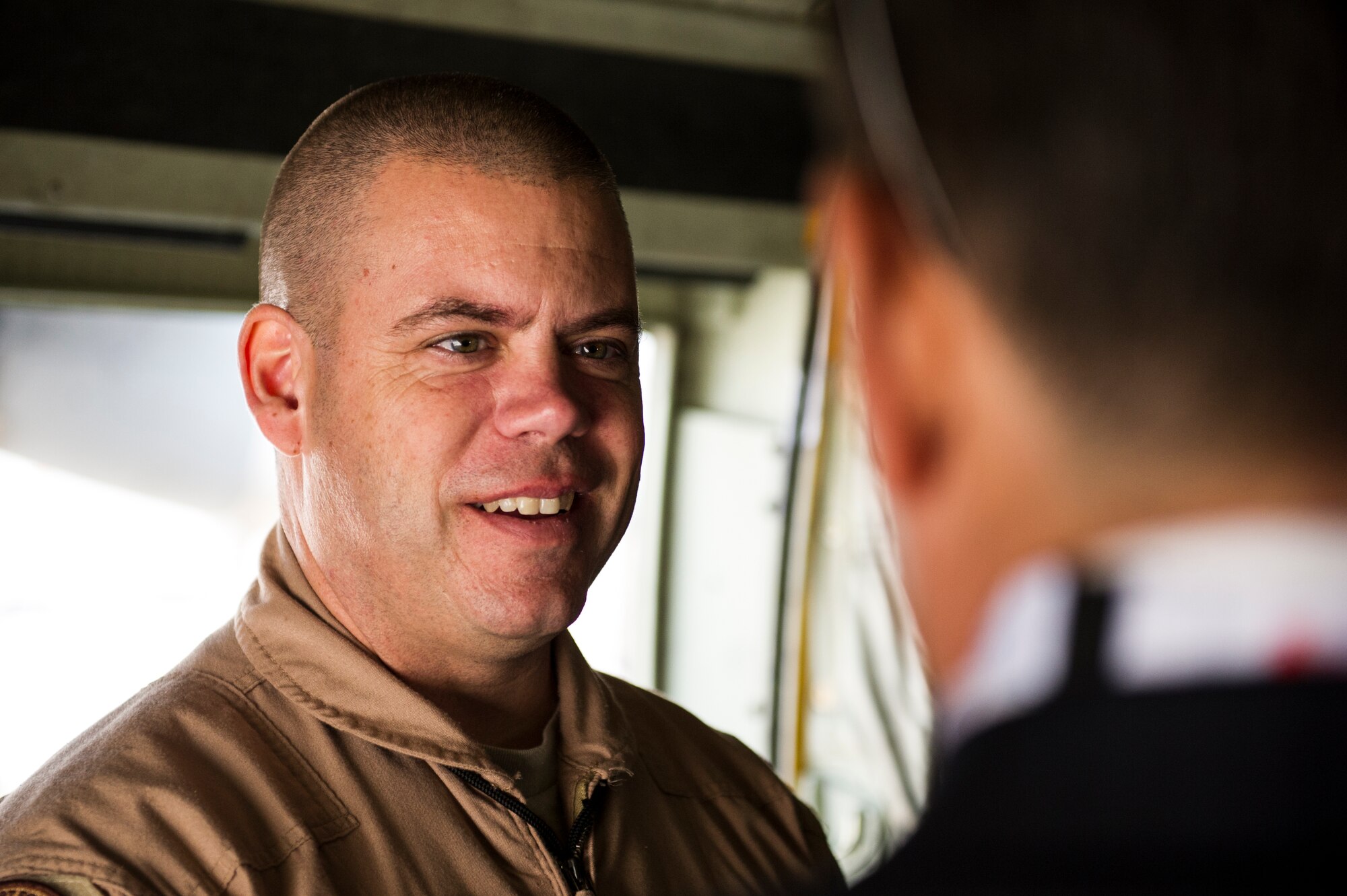 U.S. Air Force Master Sgt. Chad Gurnon, 737th Expeditionary Airlift Squadron loadmaster, talks with guest touring a C130J Super Hercules at the 2014 Bahrain International Airshow, Jan. 16, 2014. The C130J and crew are deployed from the 143rd Airlift Wing, Rhode Island Air National Guard. The BIAS will be the 16th - 18th of Jan.  The U.S. will support several aviation static displays. The aircraft the U.S. is showcasing through static displays is the C-130J Hercules, F-15E Strike Eagle, F-18E/F Hornet, MV-22 Osprey, and UH-1Y Huey Venom, AH-1Z Viper and MH-53E Sea Dragon helicopters.  The U.S. Air Force will also have a B-1 Lancer and F-22 Raptor flyby.    (U.S. Air Force photo by Staff Sgt. Stephany Richards)