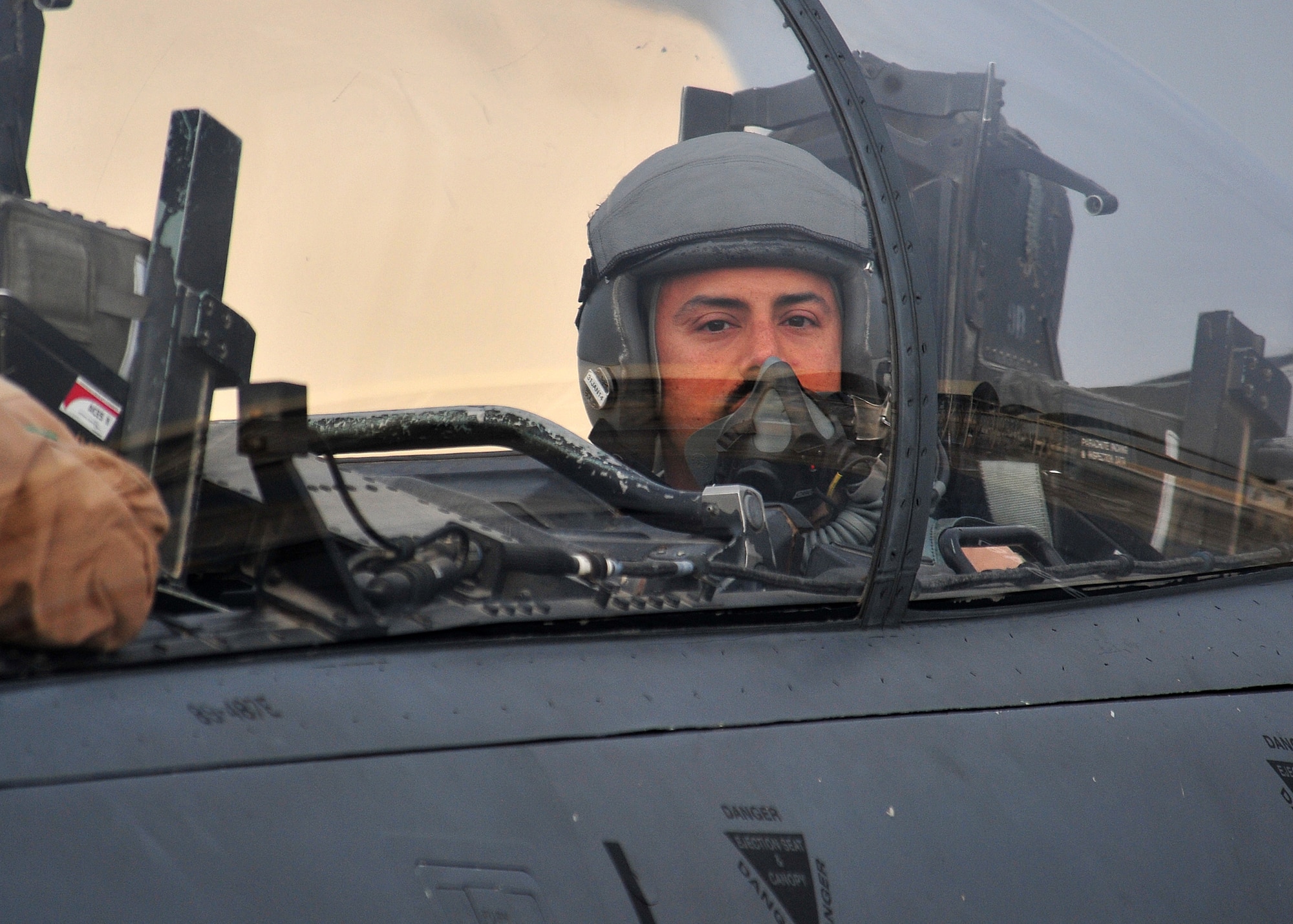 Air Force Maj. “Dozer,” 335th Expeditionary Fighter Squadron weapon systems officer,
looks out of an F-15E fighter aircraft after completing his 1,000th combat flying
hour at an undisclosed location in Southwest Asia, Jan. 12, 2014. (U.S. Air Force photo by Staff Sgt. Michael Means/Released)