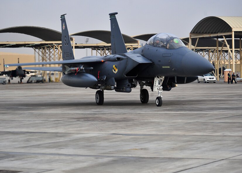 The 335th Expeditionary Fighter Squadron F-15E fighter aircraft flag ship parks after flying Air Force Maj "Dozer," a weapon systems officer assigned to the 335th Expeditionary Fighter Squadron, at an undisclosed location in Southwest Asia, Jan. 12, 2014. Dozer just completed his 1,000th combat flying hour. (U.S. Air Force photo by Staff Sgt. Michael Means/Released)