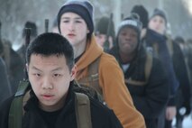 Poolees hike through the forest around historic Fort Snelling as Marines at Marine Corps Recruit Sub Station Roseville take them on a six-mile hike, Jan. 19, as part of a Marine Corps poolee function. The Marines' goal was to prepare the poolees for boot camp, as well as foster a sense of brotherhood among the poolees. Poolees carried packs and rubber rifles to simulate the heavy loads they will be expected to carry in Marine Corps recruit training. 