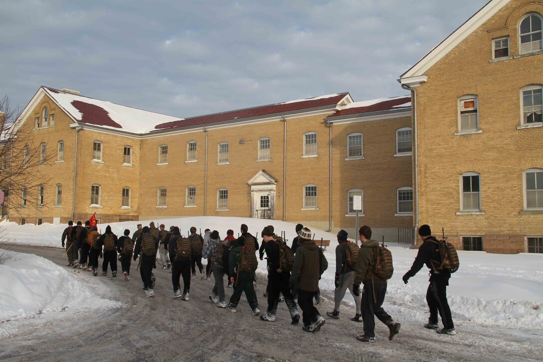 Poolees hike through the forest around historic Fort Snelling as Marines at Marine Corps Recruit Sub Station Roseville take them on a six-mile hike, Jan. 19, as part of a Marine Corps poolee function. The Marines' goal was to prepare the poolees for boot camp, as well as foster a sense of brotherhood among the poolees. Poolees carried packs and rubber rifles to simulate the heavy loads they will be expected to carry in Marine Corps recruit training.