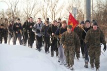 Poolees hike through the forest around historic Fort Snelling as Marines at Marine Corps Recruit Sub Station Roseville take them on a six-mile hike, Jan. 19, as part of a Marine Corps poolee function. The Marines' goal was to prepare the poolees for boot camp, as well as foster a sense of brotherhood among the poolees. Poolees carried packs and rubber rifles to simulate the heavy loads they will be expected to carry in Marine Corps recruit training.