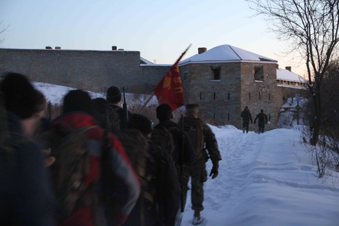 Poolees hike through the forest around historic Fort Snelling as Marines at Marine Corps Recruit Sub Station Roseville take them on a six-mile hike, Jan. 19, as part of a Marine Corps poolee function. The Marines' goal was to prepare the poolees for boot camp, as well as foster a sense of brotherhood among the poolees. Poolees carried packs and rubber rifles to simulate the heavy loads they will be expected to carry in Marine Corps recruit training.