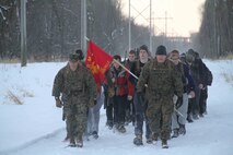 Poolees hike through the forest around historic Fort Snelling as Marines at Marine Corps Recruit Sub Station Roseville take them on a six-mile hike, Jan. 19, as part of a Marine Corps poolee function. The Marines' goal was to prepare the poolees for boot camp, as well as foster a sense of brotherhood among the poolees. Poolees carried packs and rubber rifles to simulate the heavy loads they will be expected to carry in Marine Corps recruit training.