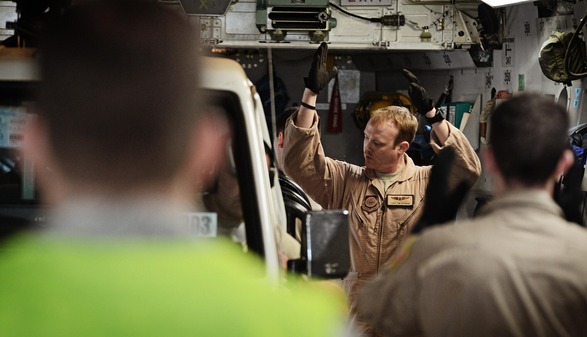 Tech. Sgt. Tim Raymon directs a driver into position on a C-17 Globemaster III while picking up soldiers and equipment in Rwanda, Jan. 19, 2014. Raymon is a loadmaster with the 62nd Airlift Wing. U.S. forces will transport a total number of 850 Rwandan soldiers and more than 1,000 tons of equipment into the Central African Republic to aid French and African Union operations against militants during this three weeklong operation. (U.S. Air Force photo Staff Sgt. Ryan Crane)