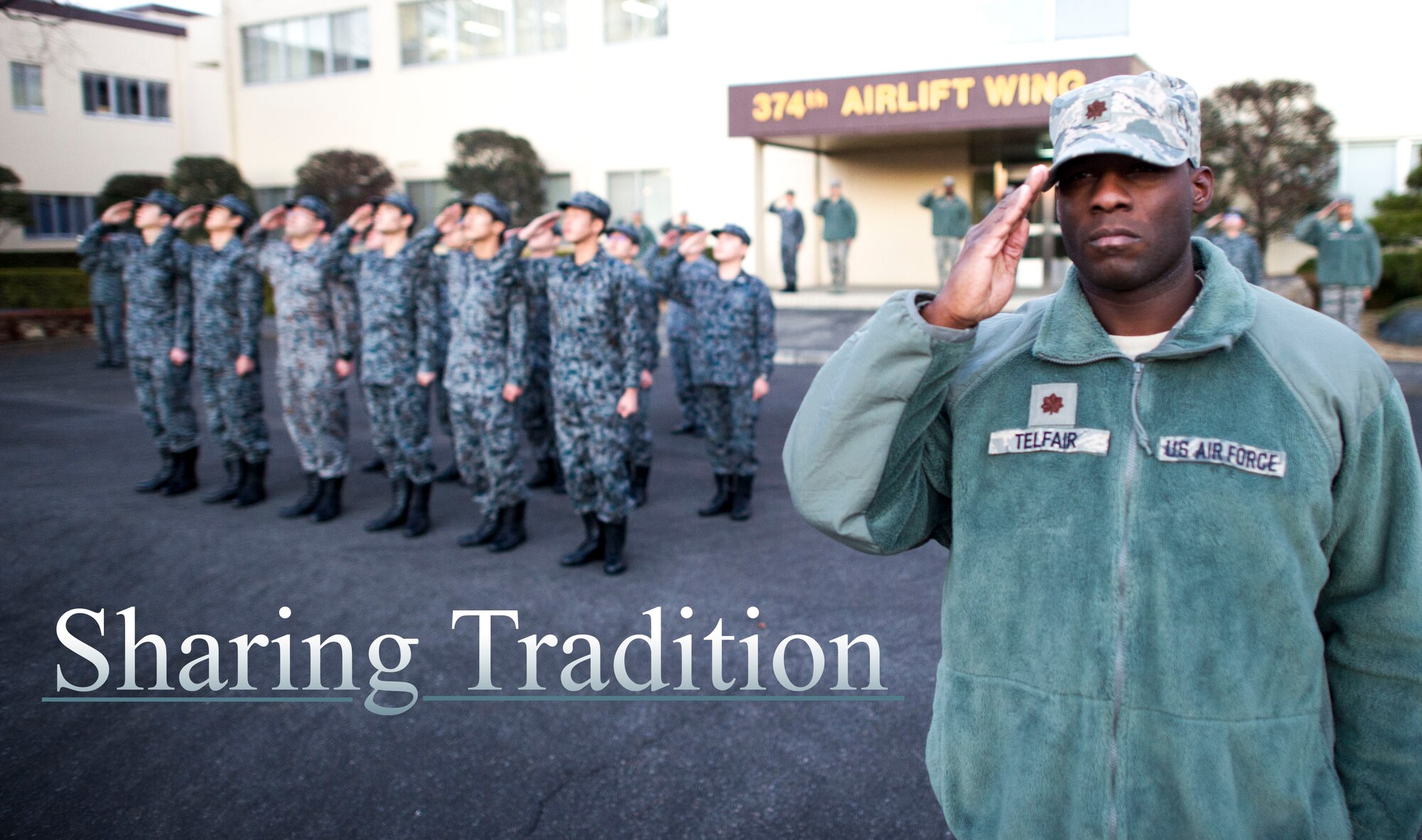 Maj. Tywann Telfair, 374th Civil Engineer Squadron, salutes during a retreat ceremony Jan. 17, 2014 at Yokota Air Base, Japan.  This retreat is the first ever bilateral wing retreat with 12 Air Force members and 12 Japanese Air Self-Defense Force members in formation. (U.S. Air Force Photo by Staff Sgt Stacy Moless) 