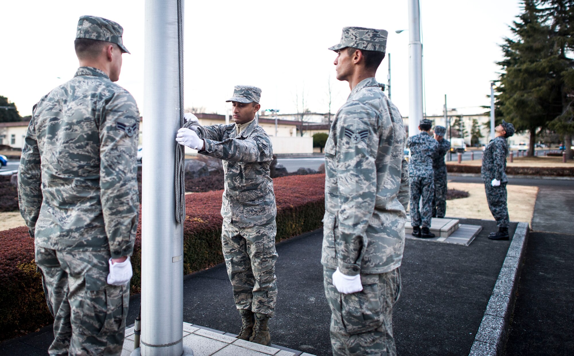 Airmen from the Yokota Air Base honor guard stand ready to perform a retreat ceremony Jan. 17, 2014 at Yokota Air Base, Japan. The retreat ceremony both signals the end of the official duty day and serves as a ceremony for paying respect to the flag.  (U.S. Air Force Photo by Staff Sgt Stacy Moless) 