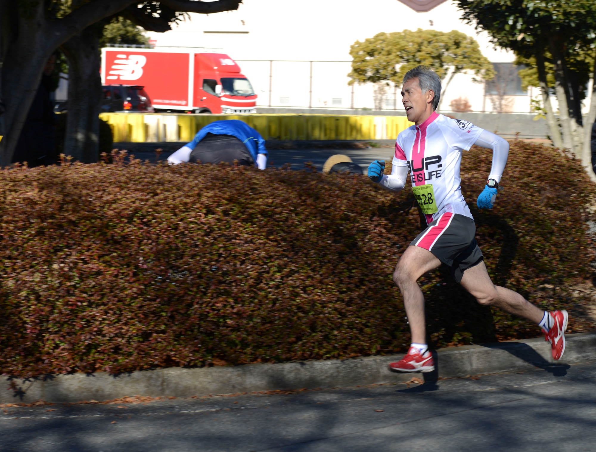 An off-base guest runs to the finish line during the annual Frostbite Run at Yokota Air Base, Japan, Jan.19, 2014. There were four different races available for guests and their families to compete in. (U.S. Air Force photo by Airman 1st Class Meagan Schutter/Released)