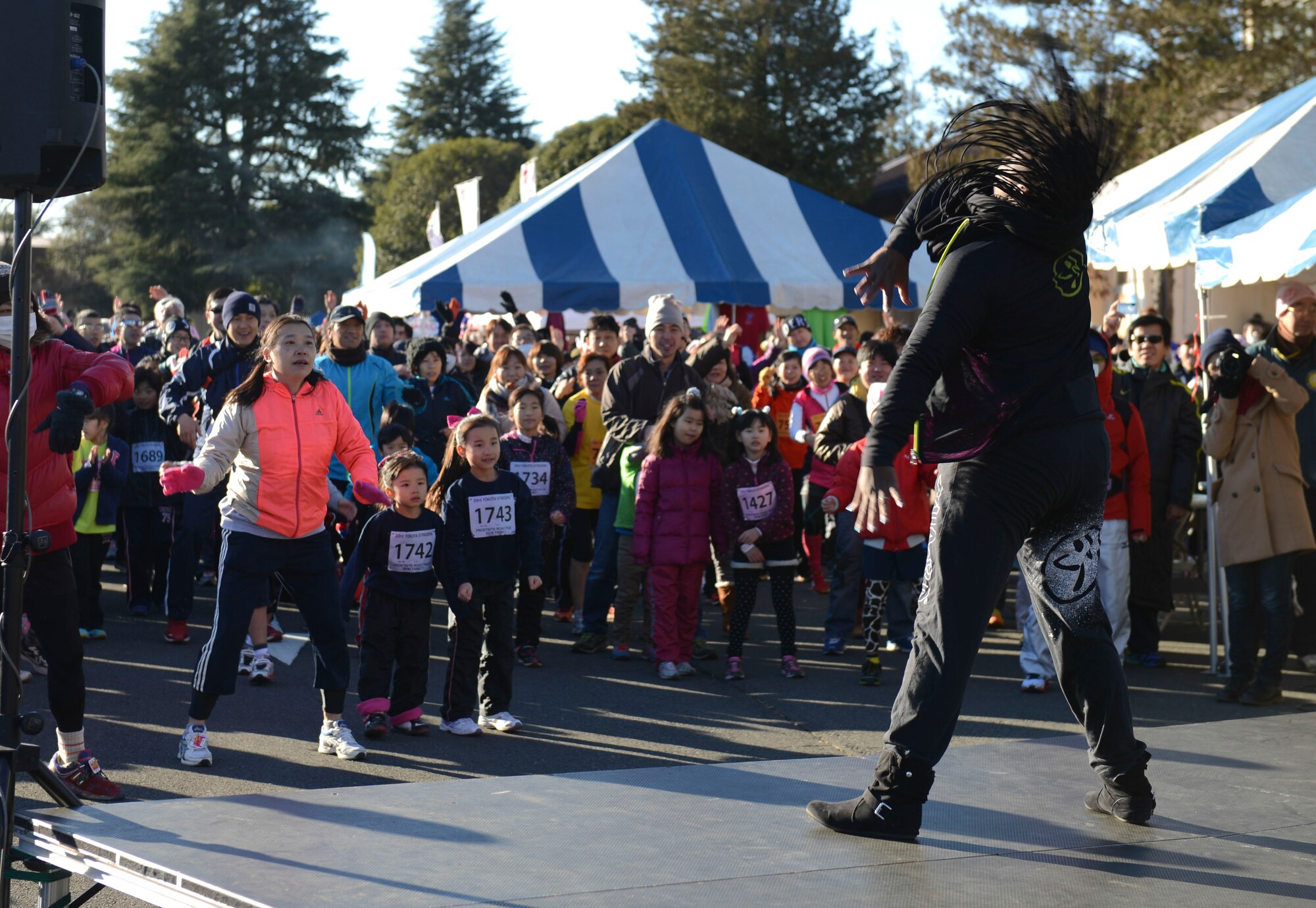 Staff Sgt. Treshawna Gwendo, 374th Aerospace Medicine Squadron, leads a Zumba Fitness warm up before the annual Frostbite Run at Yokota Air Base, Japan, Jan.19, 2014.  Sessions were conducted between the races to help stretch and warm up the runners' muscles. (U.S. Air Force photo by Airman 1st Class Meagan Schutter/Released)
