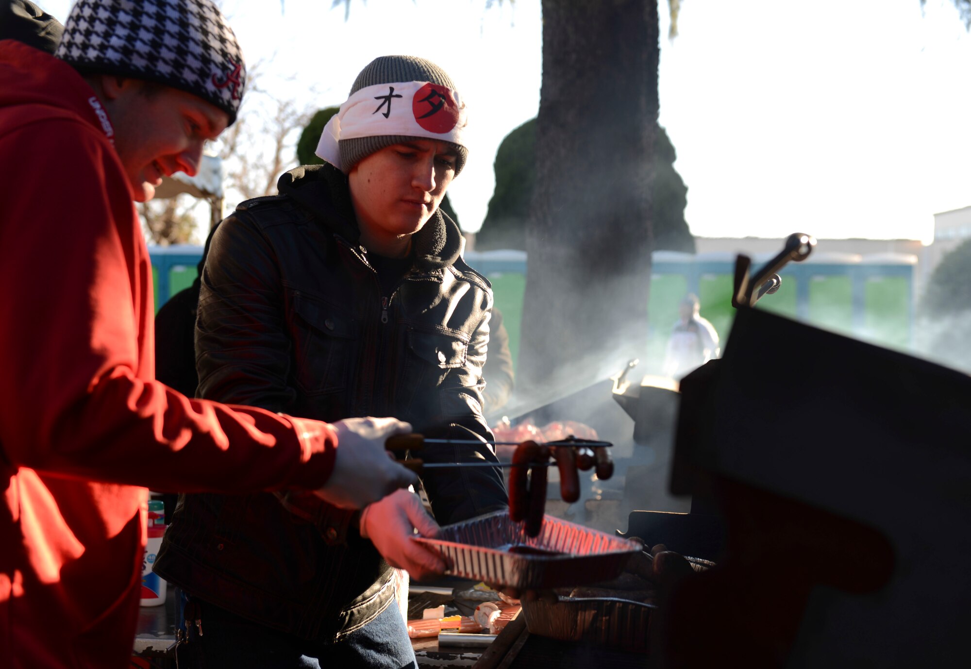 Senior Airman Travis Walden and Airman 1st Class Karius Kiracofe, 730th Air Mobility Squadron passenger service agents, prepare food for the runners during the annual Frostbite Run at Yokota Air Base, Japan, Jan.19, 2014.  There were a number of food and variety booths set up for the public to shop at during the event. (U.S. Air Force photo by Airman 1st Class Meagan Schutter/Released)