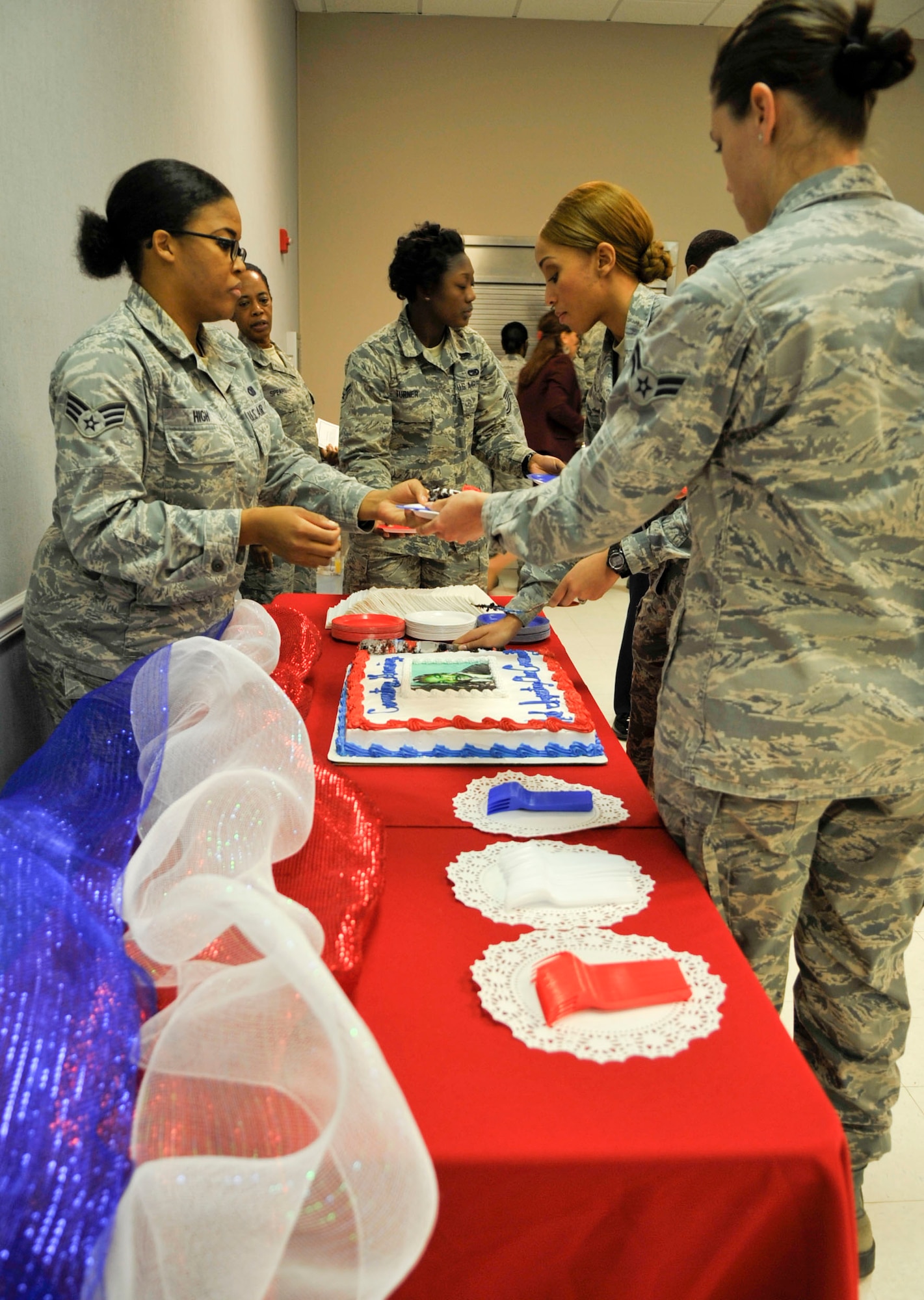 Senior Airman Kristin High, 2nd Bomb Wing, serves cake to Airmen at the Dr. Martin Luther King Jr. commemorative service reception at the Chapel 2 Annex on Barksdale Air Force Base, Jan. 16, 2014. The event was a reminder of the service of Dr. King and how Airmen and their families can be courageous and serve others. (U.S. Air Force photo/Airman 1st Class Benjamin Raughton)