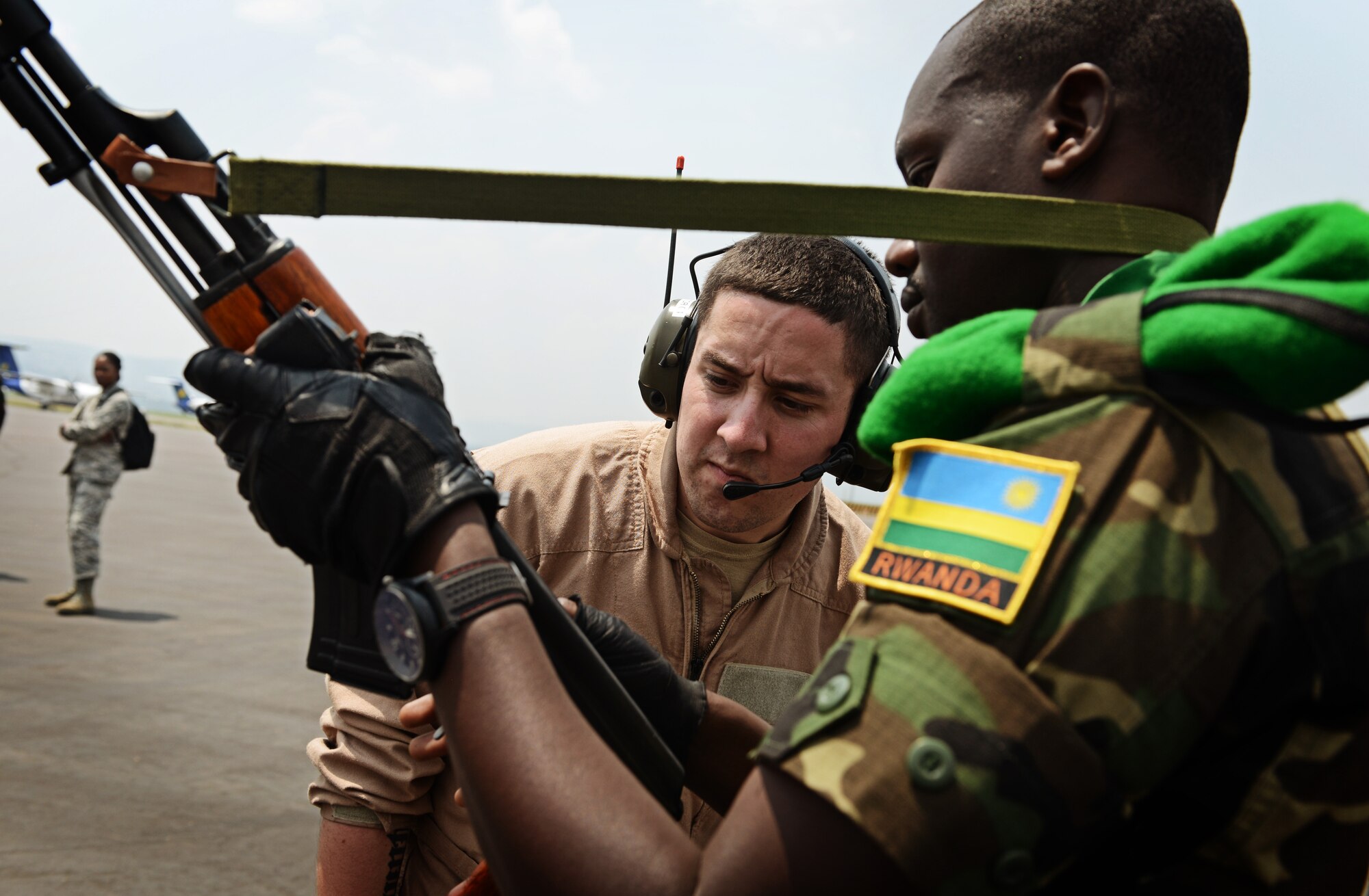 Senior Airman Chase Vento, 627th Security Forces Squadron Phoenix Raven, inspects the weapon of a Rwandan soldier prior to allowing him on the C-17 Globemaster III in Rwanda, Jan. 19, 2014. U.S. forces will transport a total number of 850 Rwandan soldiers and more than 1,000 tons of equipment into the Central African Republic to aid French and African Union operations against militants during this three weeklong operation. (U.S. Air Force photo/ Staff Sgt. Ryan Crane)