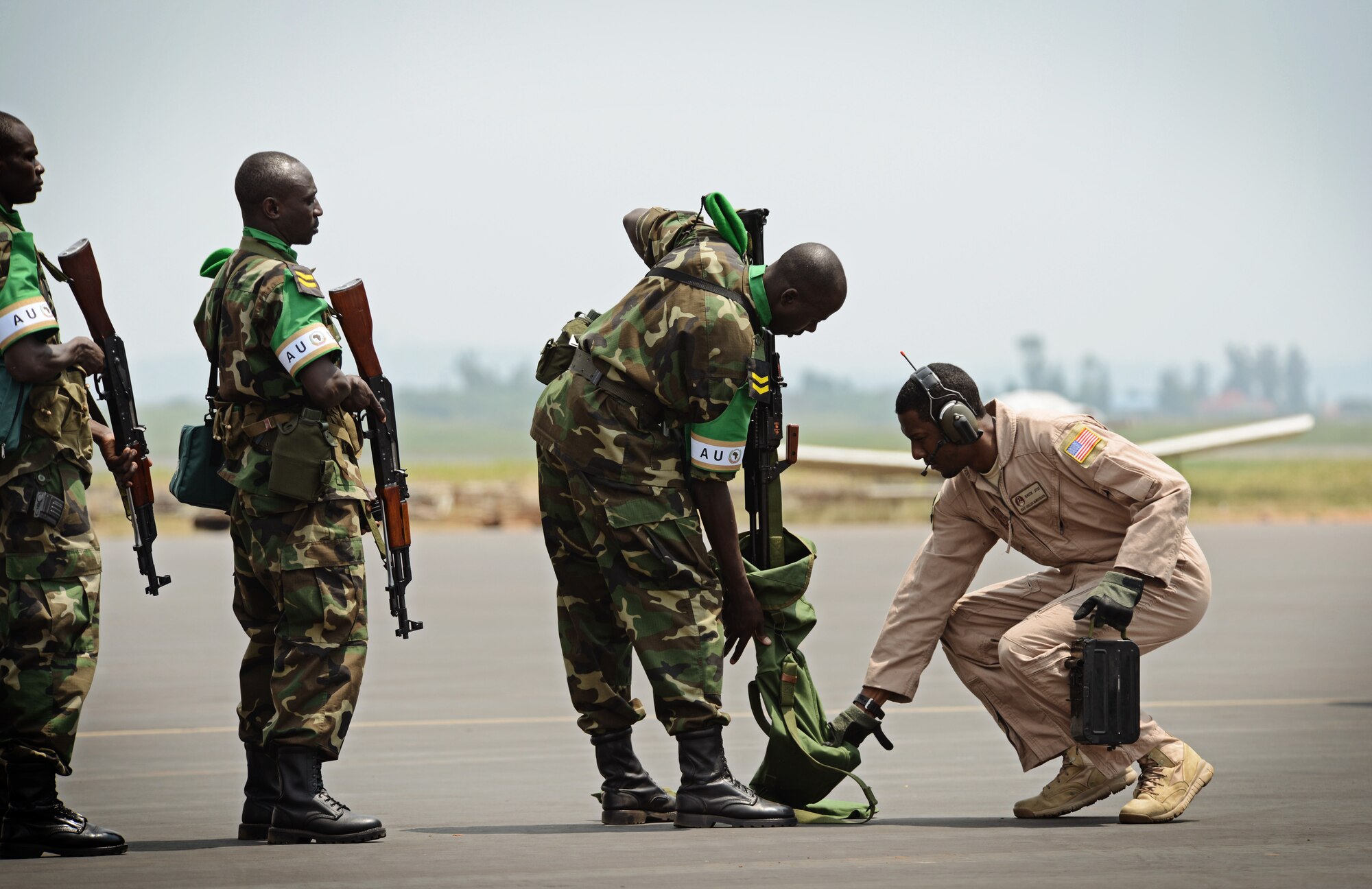 Rwandan soldiers wait in line at the Kigali airport to have their weapons inspected by Staff Sgt. Curtis McWoodson, 627th Security Forces Squadron Phoenix Raven, before getting on a C-17 Globemaster III based out of McChord Air Force Base, Wash., Jan. 19, 2014. U.S. forces will transport a total number of 850 Rwandan soldiers and more than 1,000 tons of equipment into the Central African Republic to aid French and African Union operations against militants during this three weeklong operation. (U.S. Air Force photo/ Staff Sgt. Ryan Crane)