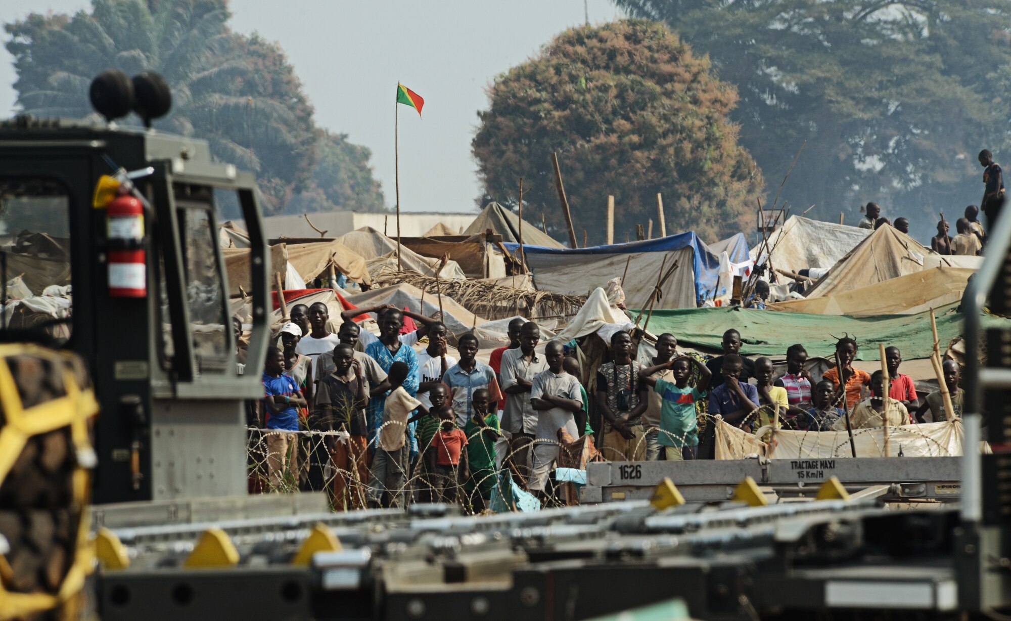 Refugees of the fighting in the Central African Republic observe the Rwandan soldiers being dropped off to fight the rebels here Jan. 19, 2014. U.S. forces will transport a total number of 850 Rwandan soldiers and more than 1000 tons of equipment into the Central African Republic to aid French and African Union operations against militants during this three week-long operation. (U.S. Air Force photo/ Staff Sgt. Ryan Crane)