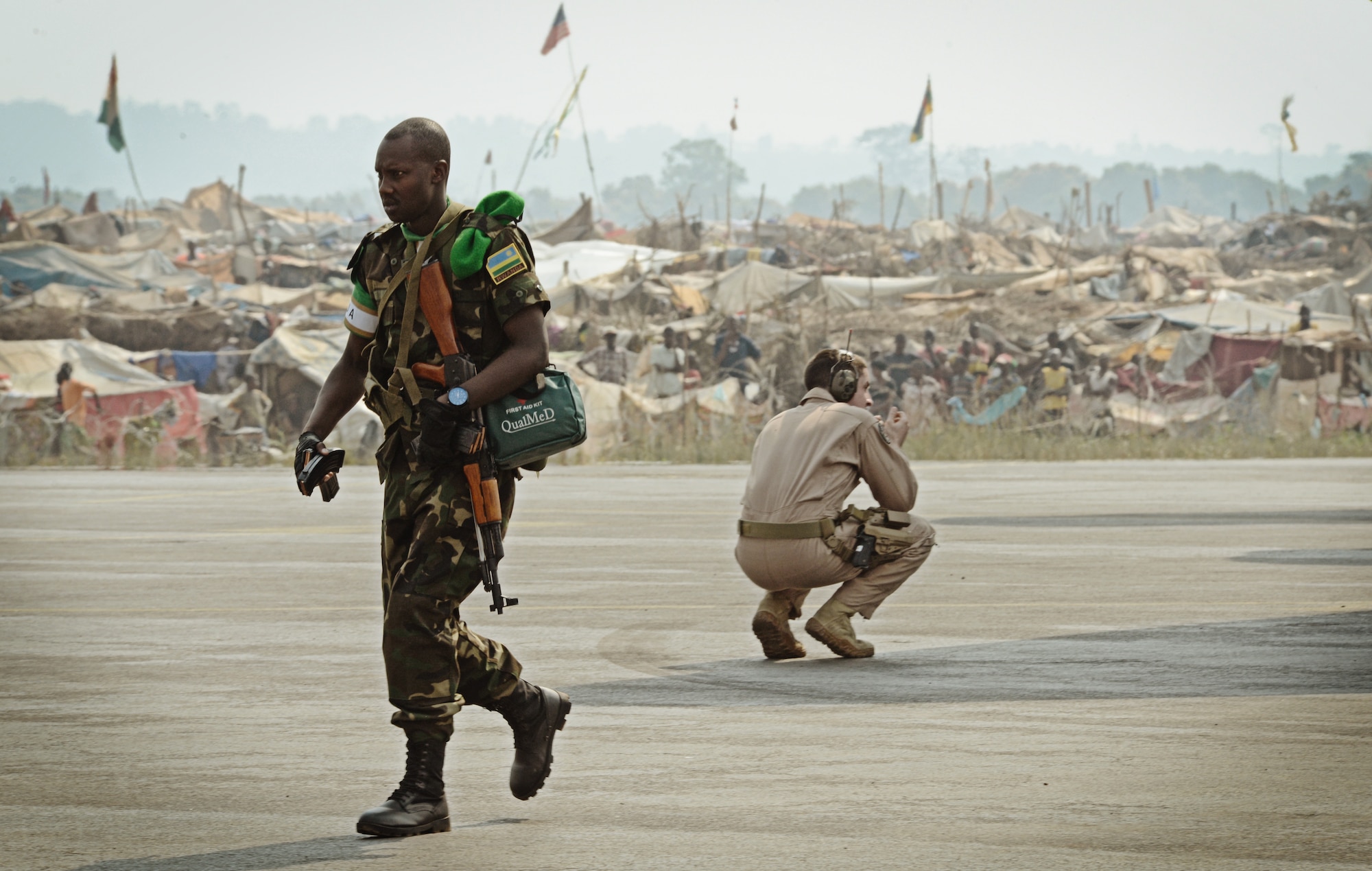 Rwandan soldiers exit a C-17 Globemaster III based out of McChord Air Force Base, Wash. in the Central African Republic with a refugee camp 100 yards away full of displaced locals due to fighting Jan. 19, 2014. U.S. forces will transport a total number of 850 Rwandan soldiers and more than 1000 tons of equipment into the Central African Republic to aid French and African Union operations against militants during this three week-long operation. (U.S. Air Force photo/ Staff Sgt. Ryan Crane)