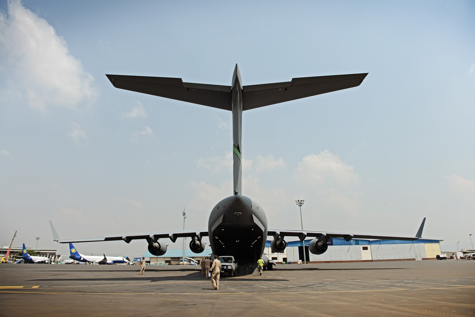 Loadmasters and aerial port crews quickly load vehicles and equipment onto a C-17 Globemaster III  in Rwanda, Jan. 19, 2014. U.S. forces will transport a total number of 850 Rwandan soldiers and more than 1,000 tons of equipment into the Central African Republic to aid French and African Union operations against militants during this three weeklong operation. (U.S. Air Force photo Staff Sgt. Ryan Crane)