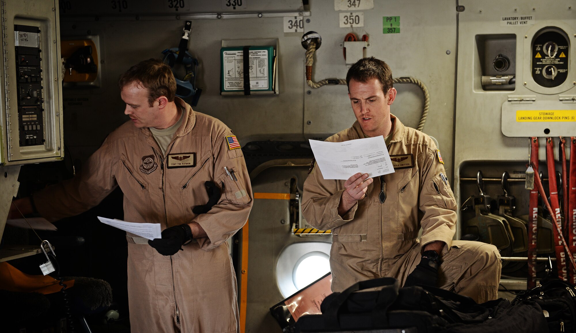 Tech. Sgt. Tim Raymon and Airman 1st Class Kyle Switzer, 62nd Airlift Wing loadmasters, review their load plan before flying into Rwanda to pick up Rwandan soldiers and equipment, Jan. 19, 2014. U.S. forces will transport a total number of 850 Rwandan soldiers and more than 1,000 tons of equipment into the Central African Republic to aid French and African Union operations against militants during this three weeklong operation. (U.S. Air Force photo Staff Sgt. Ryan Crane)