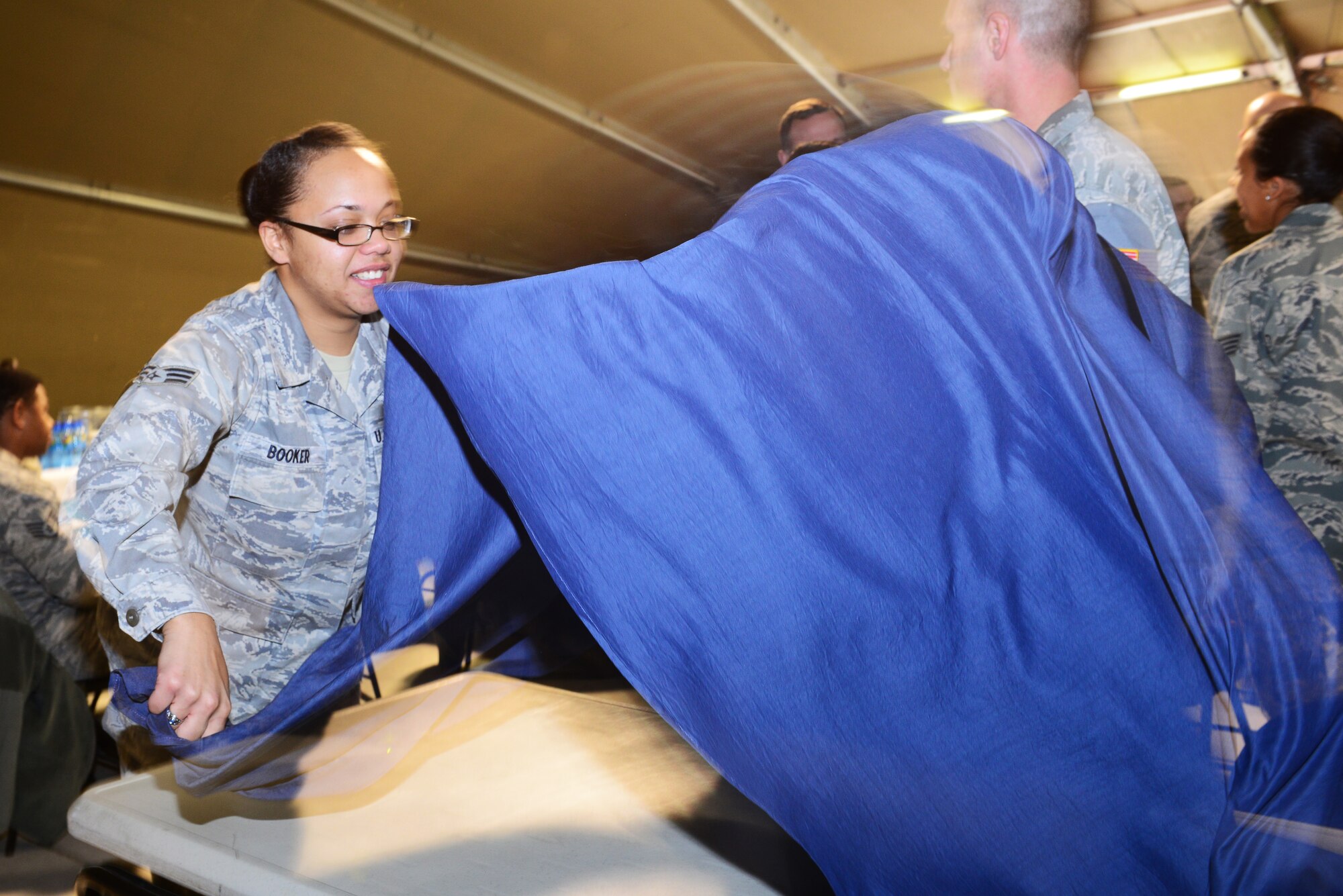 Senior Airman Brittany Booker, Martin Luther King Jr. committee president sets up a table at the MLK Luncheon at Transit Center at Manas, Kyrgyzstan, Jan. 14, 2014.  The committee arranged four days of activities to honor the American civil-rights activist. Booker is deployed from Malmstrom Air Force Base, Mont., and a native of Marietta, Ga. (U.S. Air Force photo/Staff Sgt. Travis Edwards)