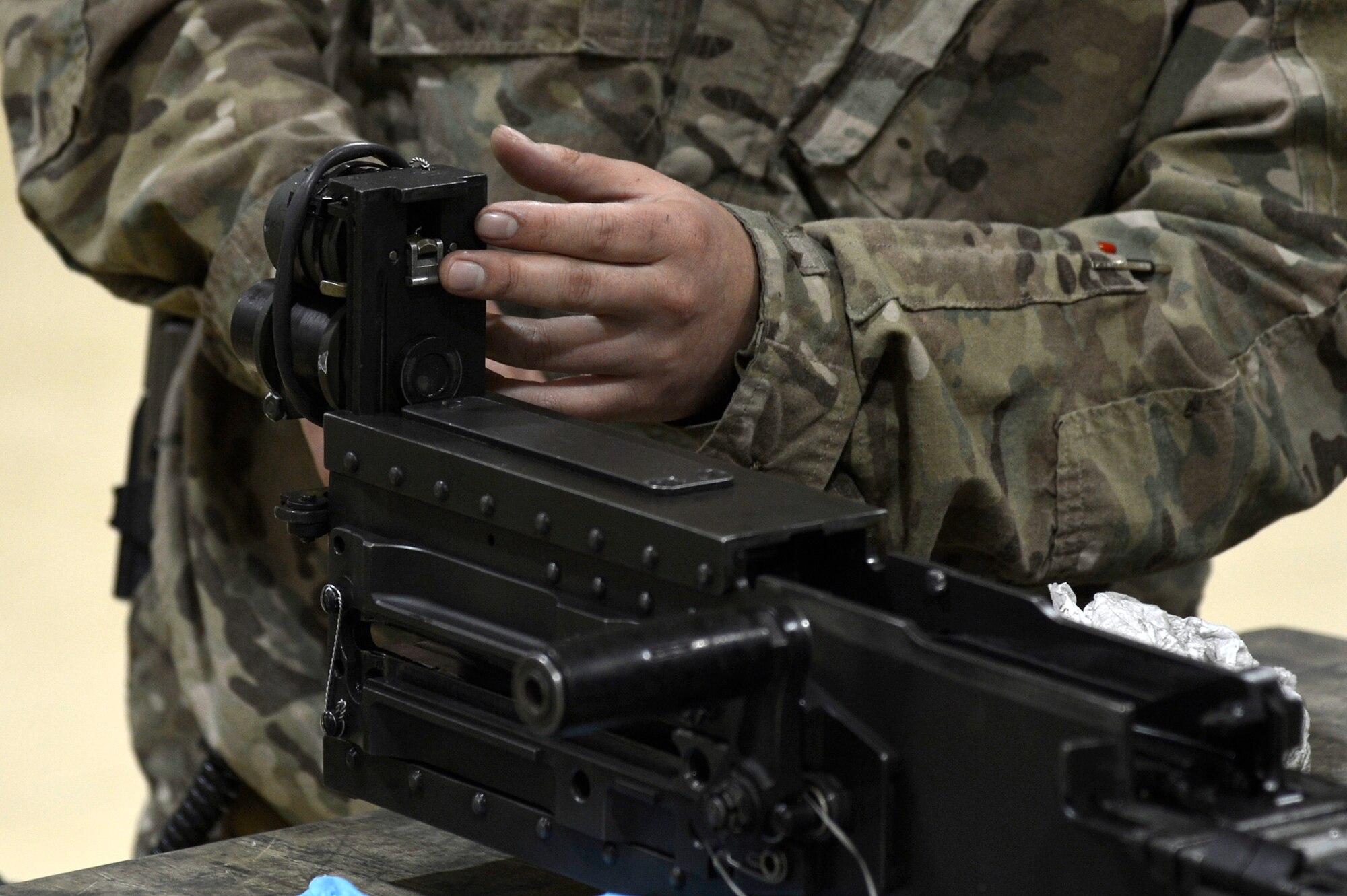 U.S. Air Force Tech. Sgt. Vincent Lopez, 83rd Expeditionary Rescue Squadron weapons expeditor, trains Airmen assigned to the 455th Expeditionary Maintenance Squadron armament shop at Bagram Airfield, Afghanistan, Jan. 19, 2014. Lopez trained the Airmen on the GAU 18 machine gun and GAU 2 mini gun, found on the HH-60G Pave Hawk. Lopez is deployed from the 718th Aircraft Maintenance Squadron at Kadena Air Base, Japan, and is a native of El Paso, Texas. (U.S. Air Force photo by Senior Airman Kayla Newman/Released)