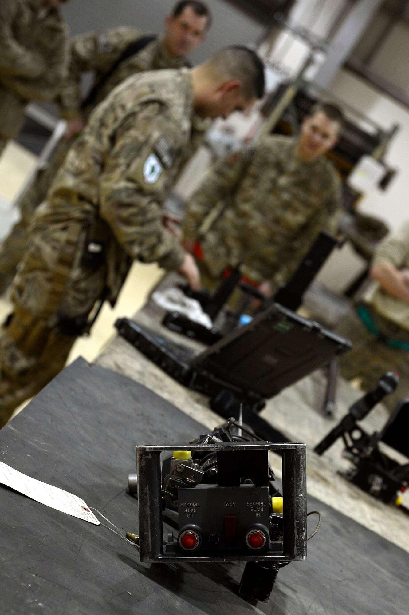 U.S. Air Force Tech. Sgt. Vincent Lopez, 83rd Expeditionary Rescue Squadron weapons expeditor, trains Airmen assigned to the 455th Expeditionary Maintenance Squadron armament shop at Bagram Airfield, Afghanistan, Jan. 19, 2014. Lopez trained the Airmen on the GAU 18 machine gun and GAU 2 mini gun, found on the HH-60G Pave Hawk. Lopez is deployed from the 718th Aircraft Maintenance Squadron at Kadena Air Base, Japan, and is a native of El Paso, Texas. (U.S. Air Force photo by Senior Airman Kayla Newman/Released)
