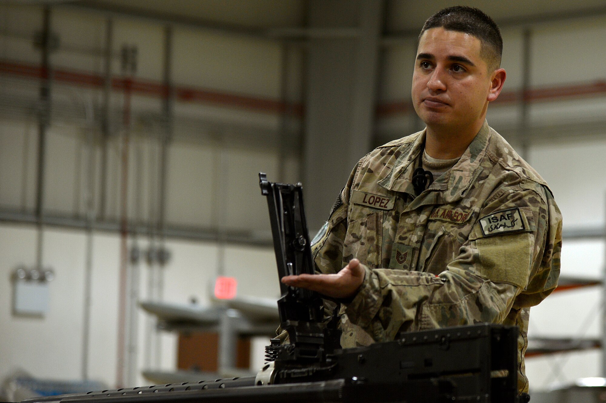 U.S. Air Force Tech. Sgt. Vincent Lopez, 83rd Expeditionary Rescue Squadron weapons expeditor, demonstrates putting together a GAU 18 machine gun at Bagram Airfield, Afghanistan, Jan. 19, 2014. Airmen assigned to the 455th Expeditionary Maintenance Squadron armament shop received training on the weapon systems of the HH-60G Pave Hawk from Lopez. Lopez is deployed from the 718th Aircraft Maintenance Squadron at Kadena Air Base, Japan, and is a native of El Paso, Texas. (U.S. Air Force photo by Senior Airman Kayla Newman/Released)
